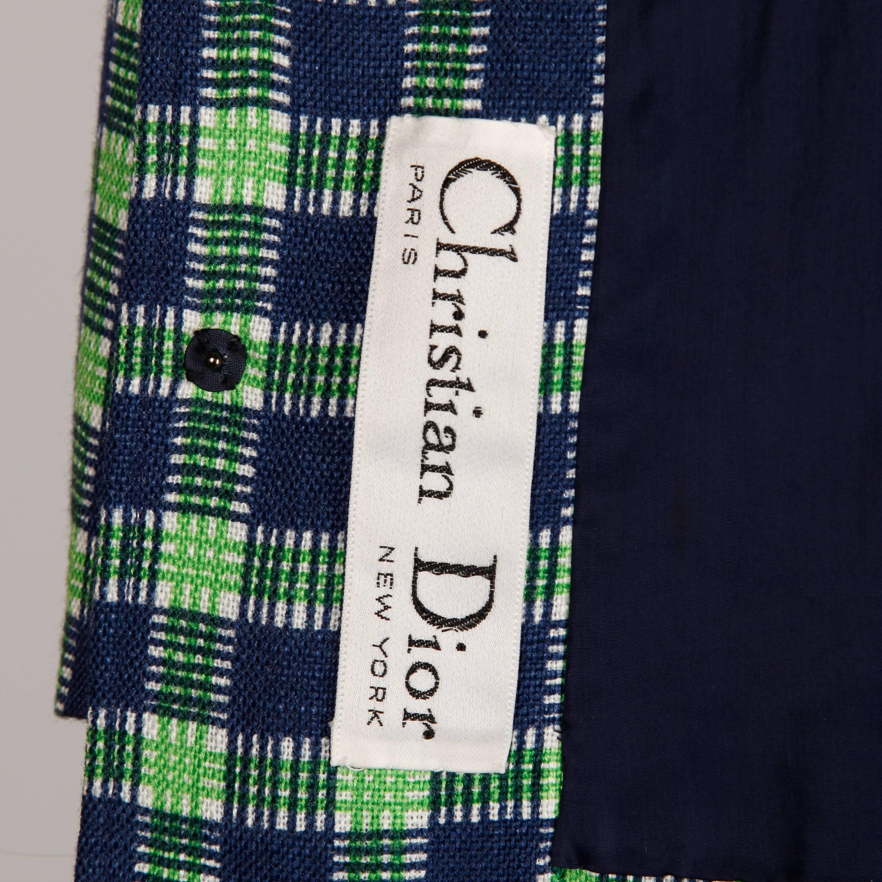 Rare 1970s Dior! Green and navy blue plaid wool double breasted jacket and skirt ensemble. Fully lined. Button and snap closure on the jacket and zip and hook closure on the skirt. The marked size is a vintage 10 and the suit fits like a modern size