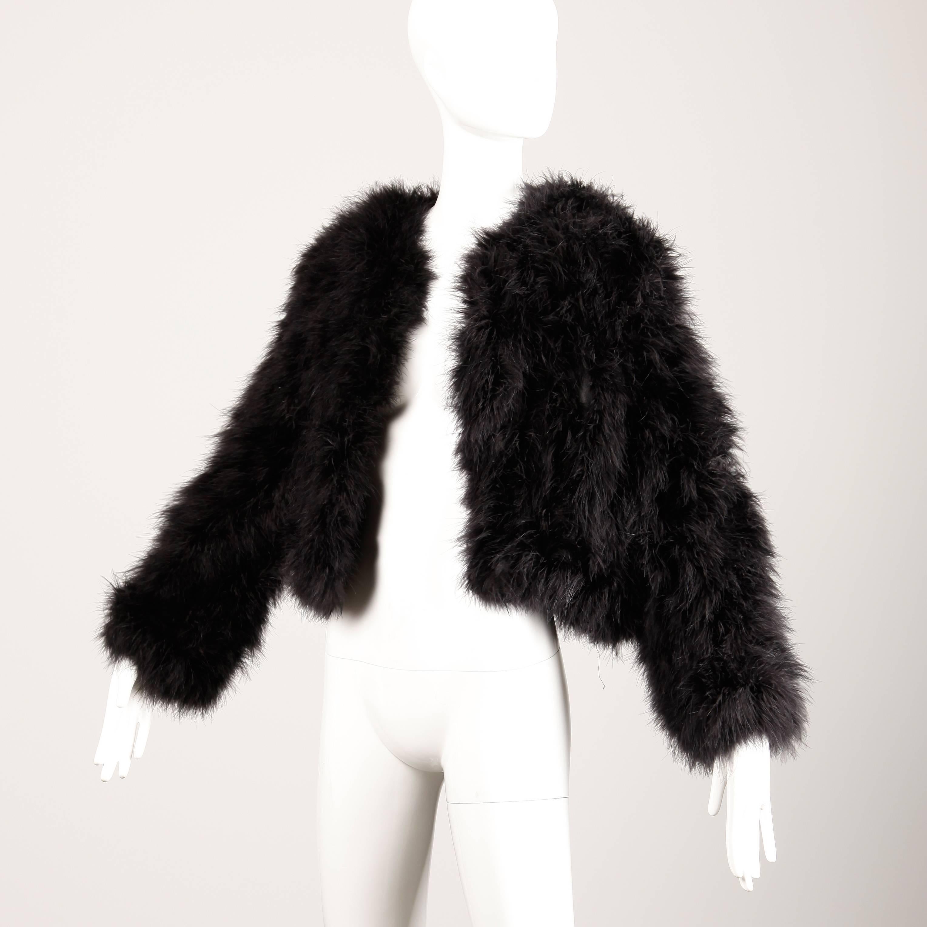Fluffy soft vintage black maribou feather jacket by Sakowitz. Fully lined with hook closure. Oversized fit looks great on sizes small-large. The bust measures 42