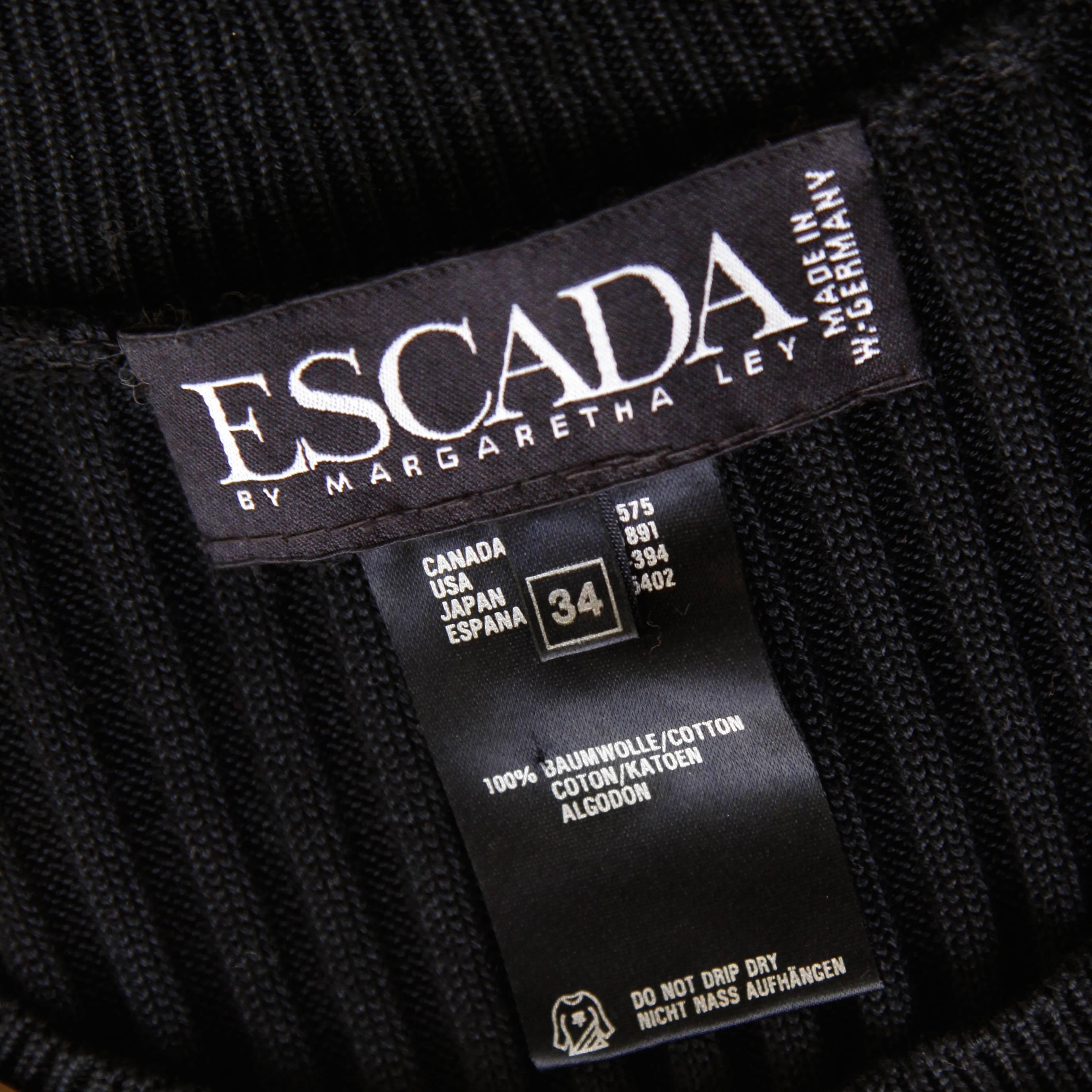 Vintage black ribbed cotton knit top by Escada with shiny gold stud appliques. Short sleeves. Unlined. 100% Cotton. The marked size is an EU 34 and the top fits like a modern size small. The bust measures 30-40", waist 24-38", and total
