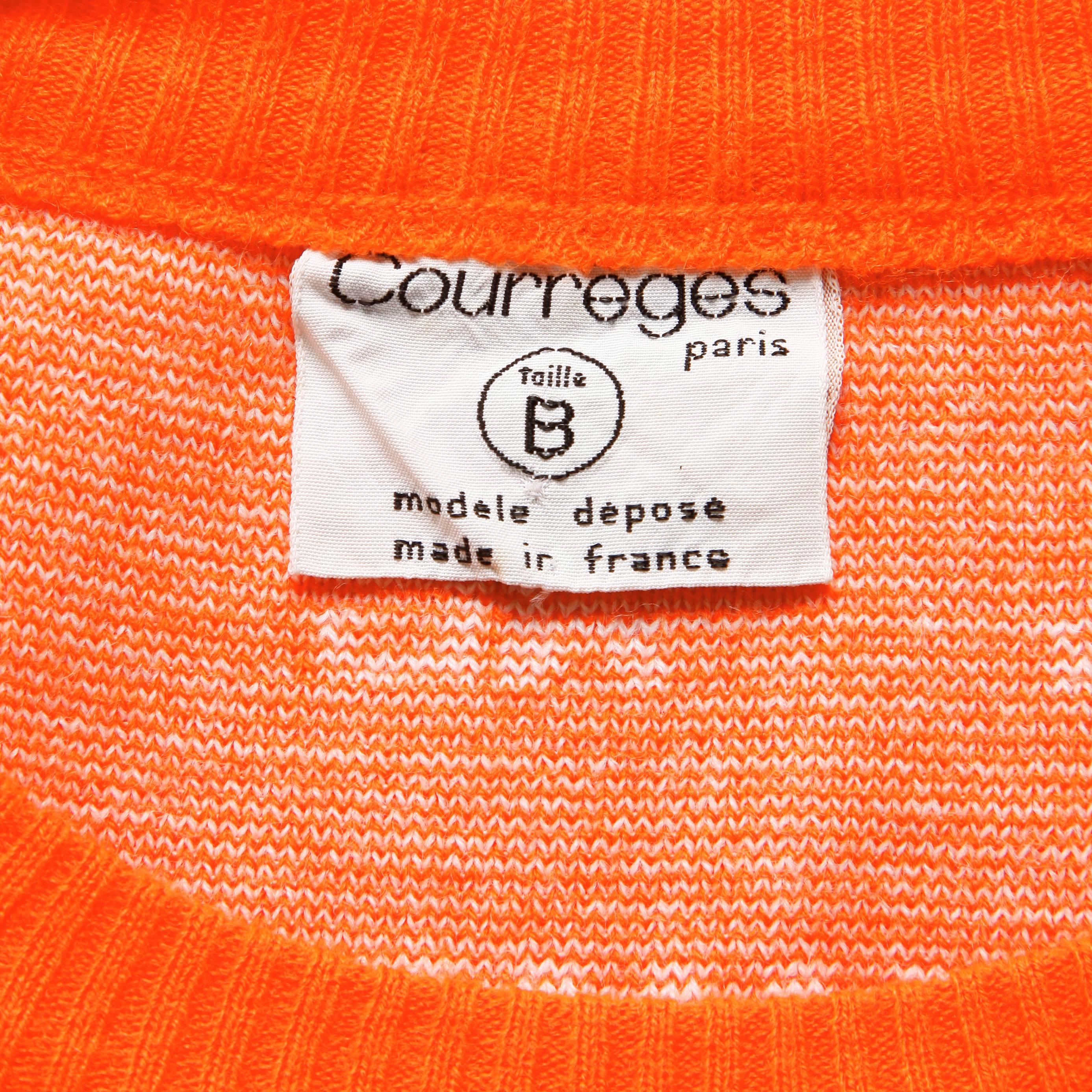Bright orange vintage Courreges sweater vest from the 1970s with the Courreges logo throughout the piece. Unlined. Pulls on. The bust measures 34-36