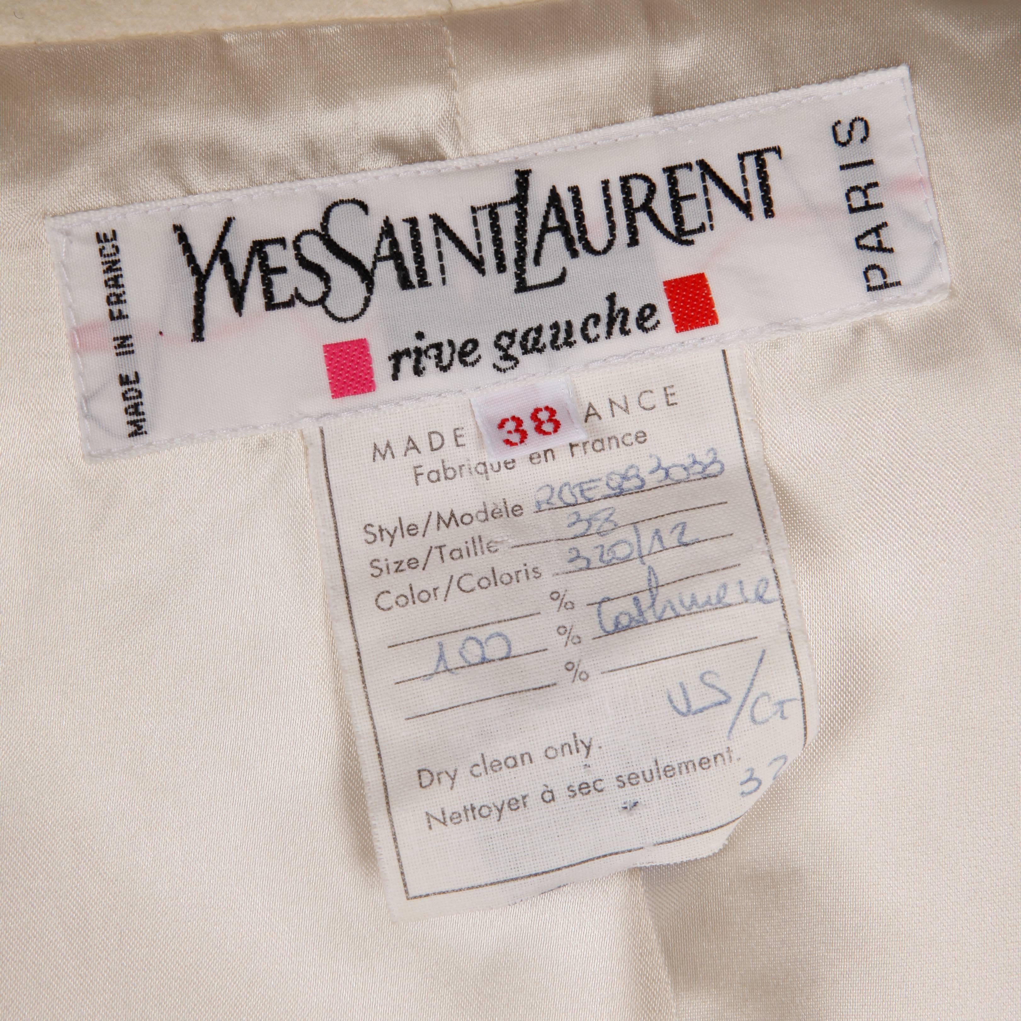 Stunning ivory 100% cashmere jacket by Yves Saint Laurent. Structured collar and front patch pockets. Fully lined. The marked size is 38 and the jacket fits like a modern size small. The bust measures 38", waist 38", shoulders 15",