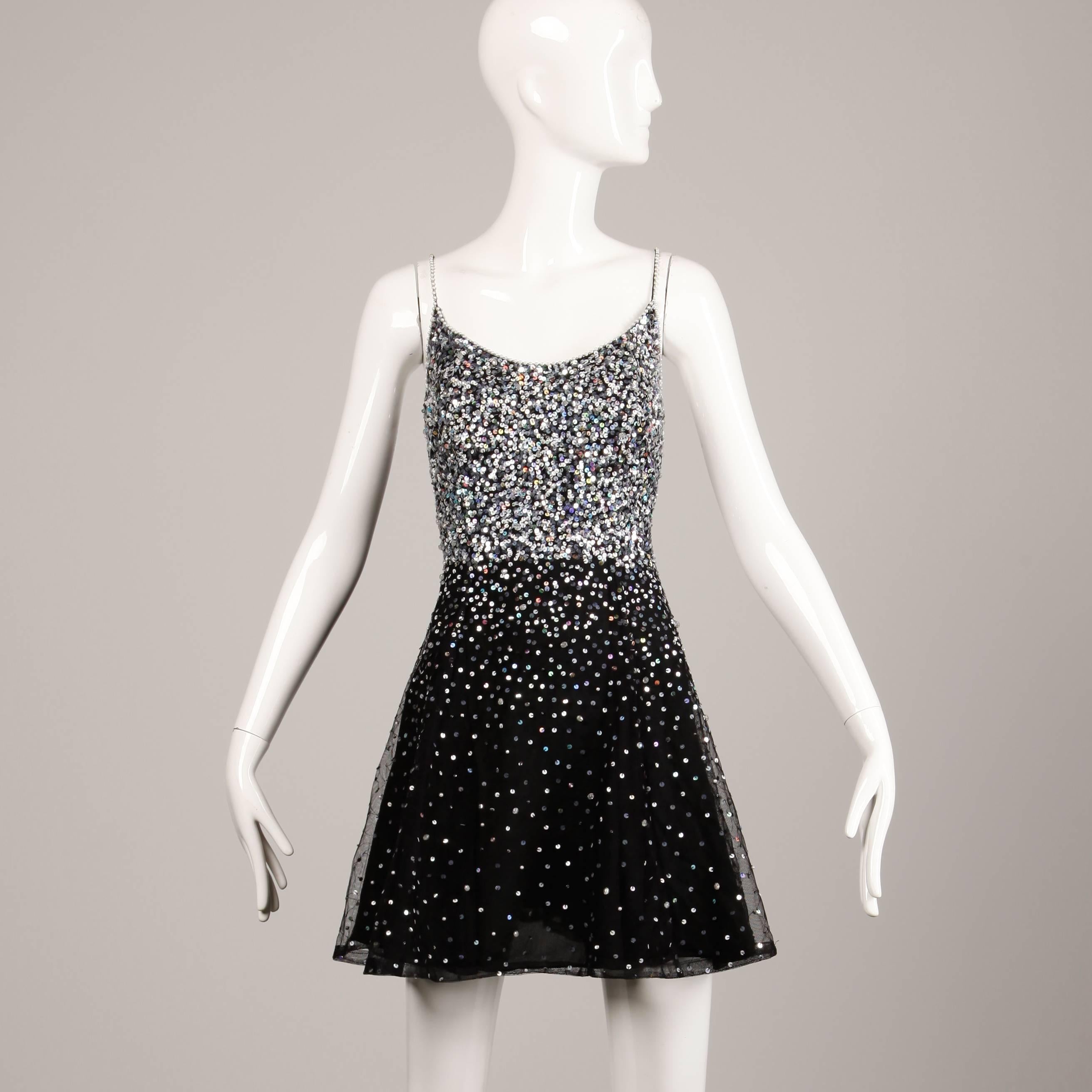 Vintage 1980s black mesh dress with sequin and beadwork. By Naeem Khan's Riazee label. Fully lined in silk with side zip closure. The marked size is 10 but the dress fits like a modern size small-medium. The bust measures 37", waist 27",