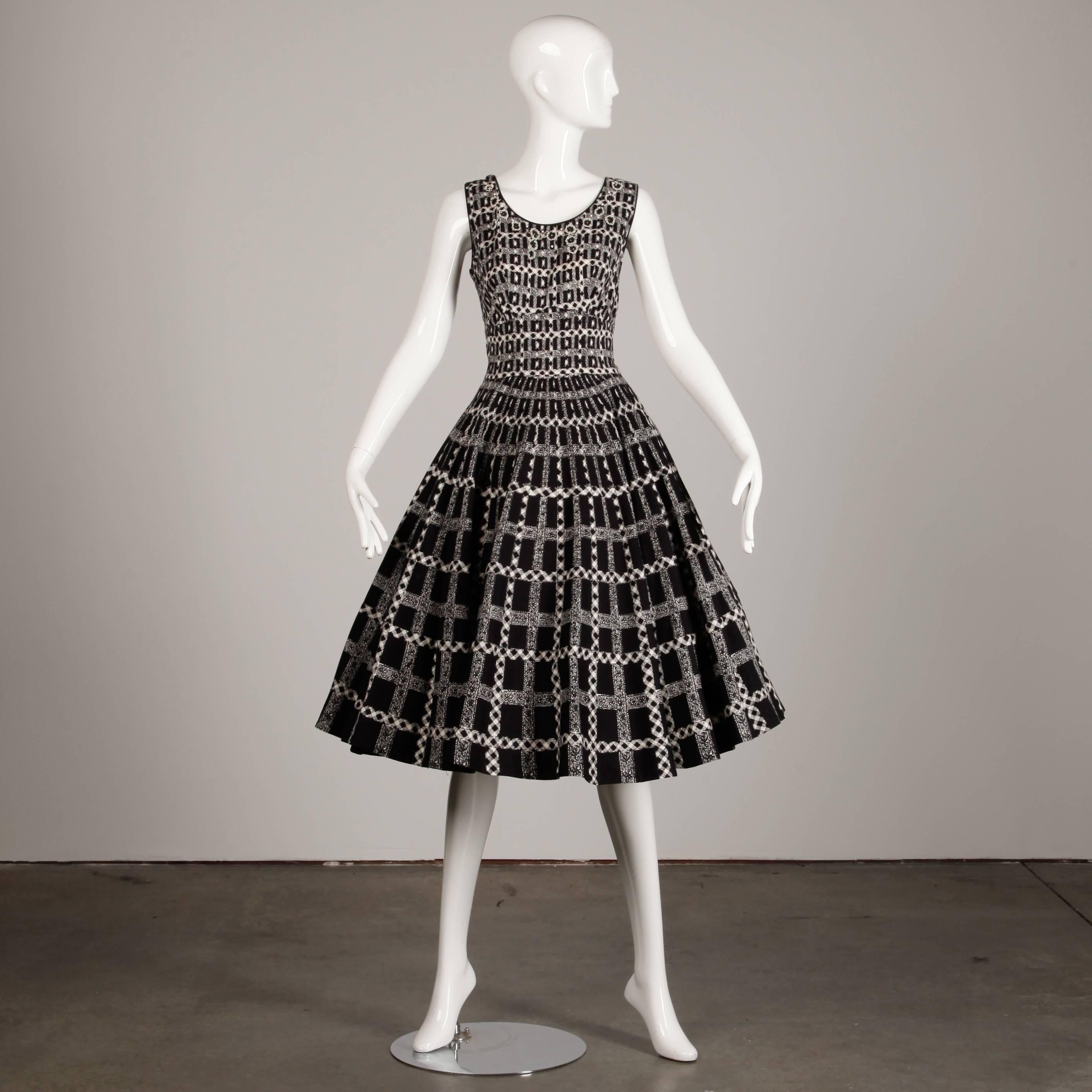 Darling 1950s black and white gingham cotton patio dress with prong set rhinestone flower appliques. Full sweep. Unlined with side metal zip closure. Dress is pictured with a crinoline under the skirt which is not included. Fits like a modern size