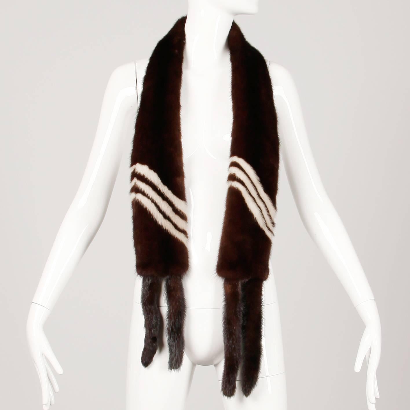 Gorgeous vintage mink fur wrap in brown and blonde stripes with mink tail trim. Genuine mink fur is glossy, silky and soft and in excellent condition (stored properly). Measures 66" total length, 3" wide in the middle, 4.5" wide at