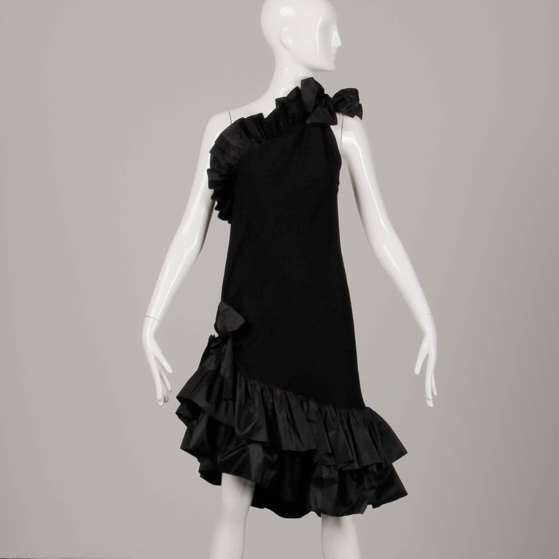 Chic 1980s vintage black ruffled evening dress with one-shoulder tie by Yves Saint Laurent. Unlined with no closure (pulls on over the head). 72% Acetate, 28% viscose. The marked size is 38/ US 6 / Small. The bust measures 40