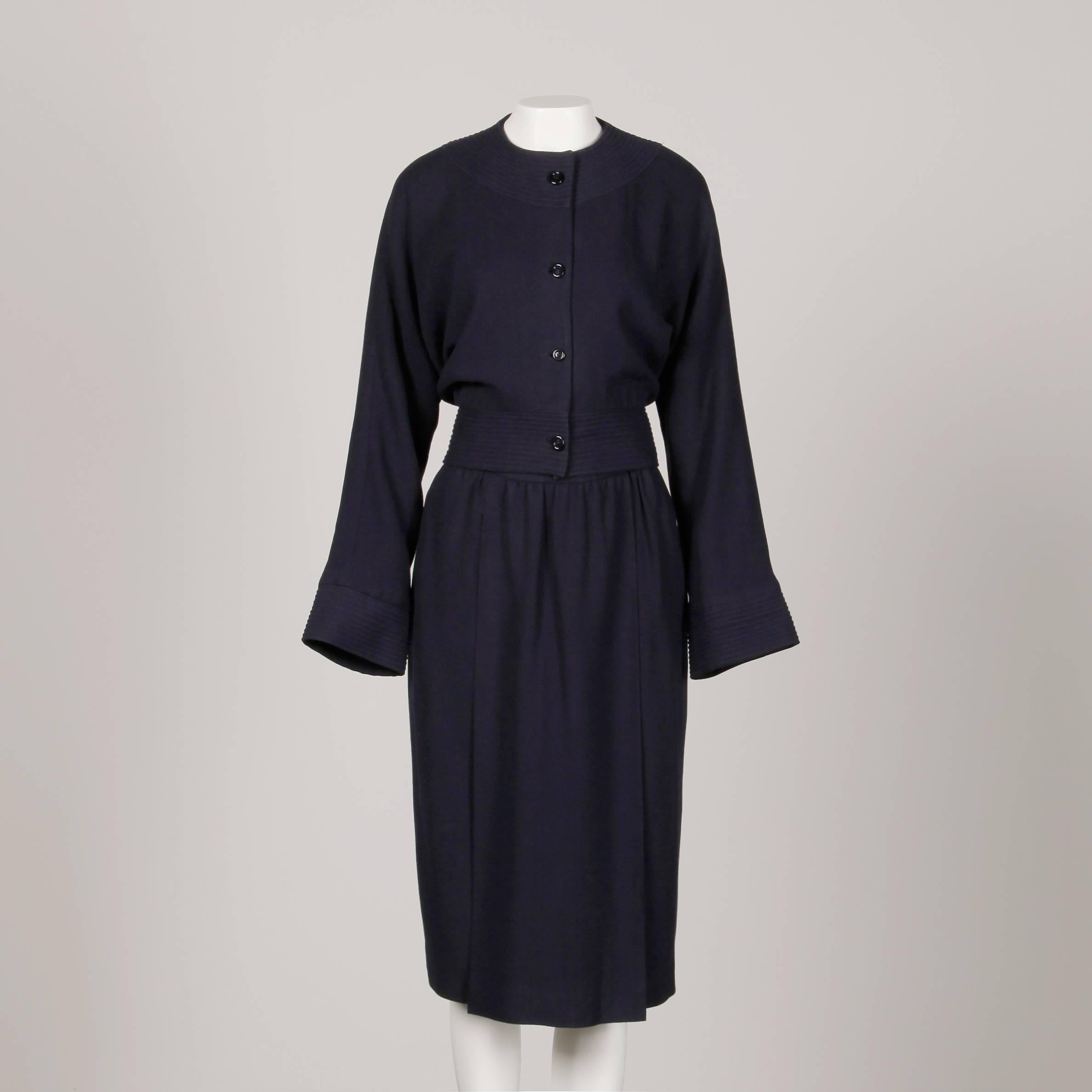 Elegant vintage 1970s navy blue wool jacket and skirt suit by Donald Brooks. The jacket is fully lined with front button and snap closure. Structured shoulder pads are sewn in underneath the lining. 100% wool. The marked size is 12. The bust