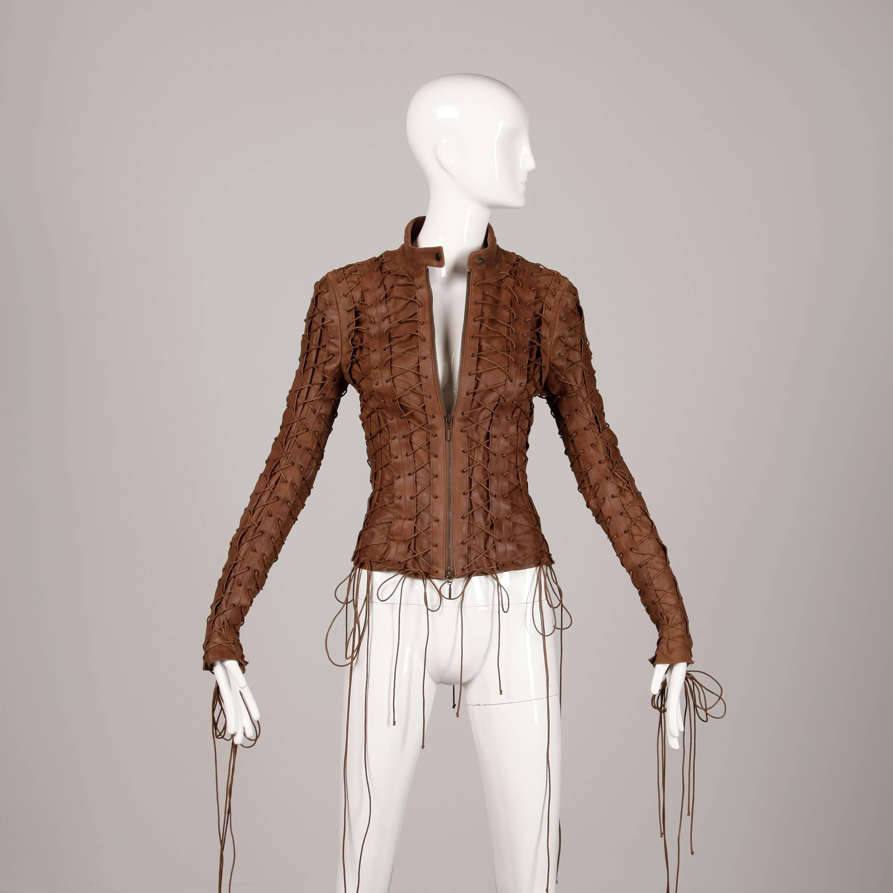 Incredible brown leather moto jacket with allover lace up detail by Faycal Amor for Plein Sud. Fully lined with front zip and snap closure. 100% leather. The marked size is 40/8, but the jacket fits like a size small-medium (adjustable due to the