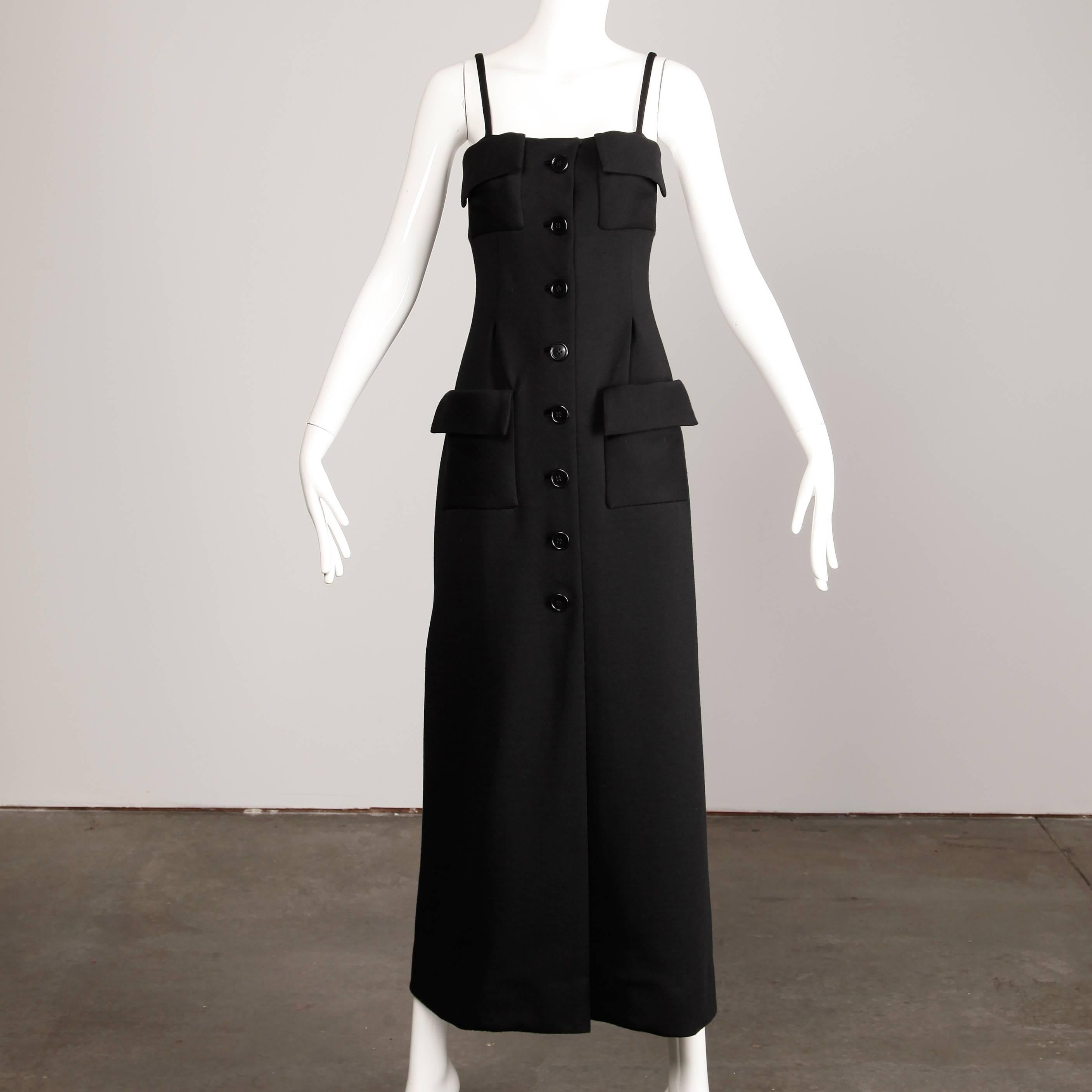 Vintage 1970s black wool maxi dress by Geoffrey Beene. Fully lined with front button and snap closure. Front patch pockets. Fits like a modern size small-medium. The bust measures 32", the waist 28.5", hips 35" and the total length is