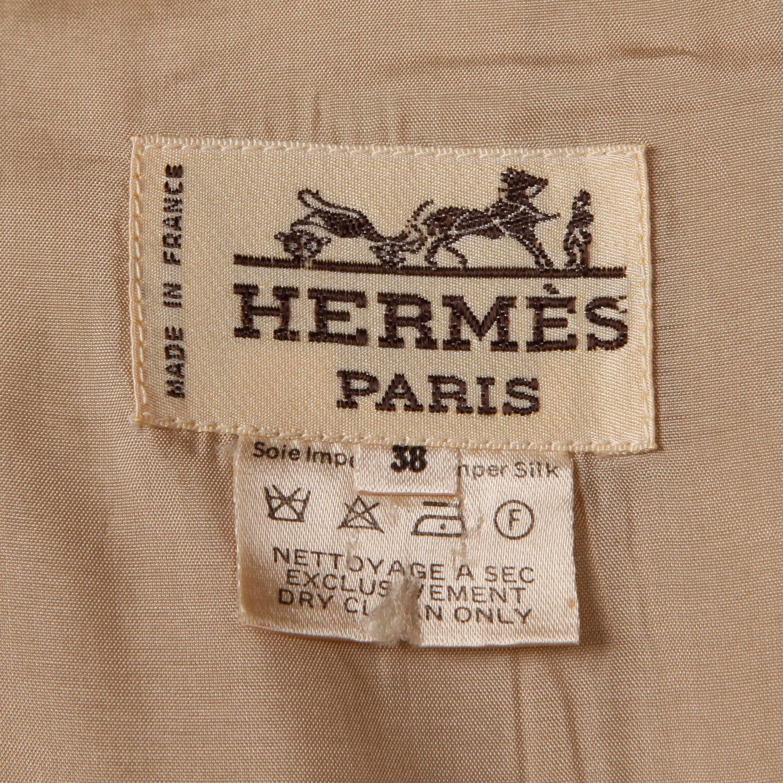 Gorgeous vintage taupe silk trench coat by Hermes. Partially lined in silk with pockets and matching sash belt. The marked size is 38, but the coat will fit modern sizes small-large on account of the oversized fit. The bust measures 40", waist
