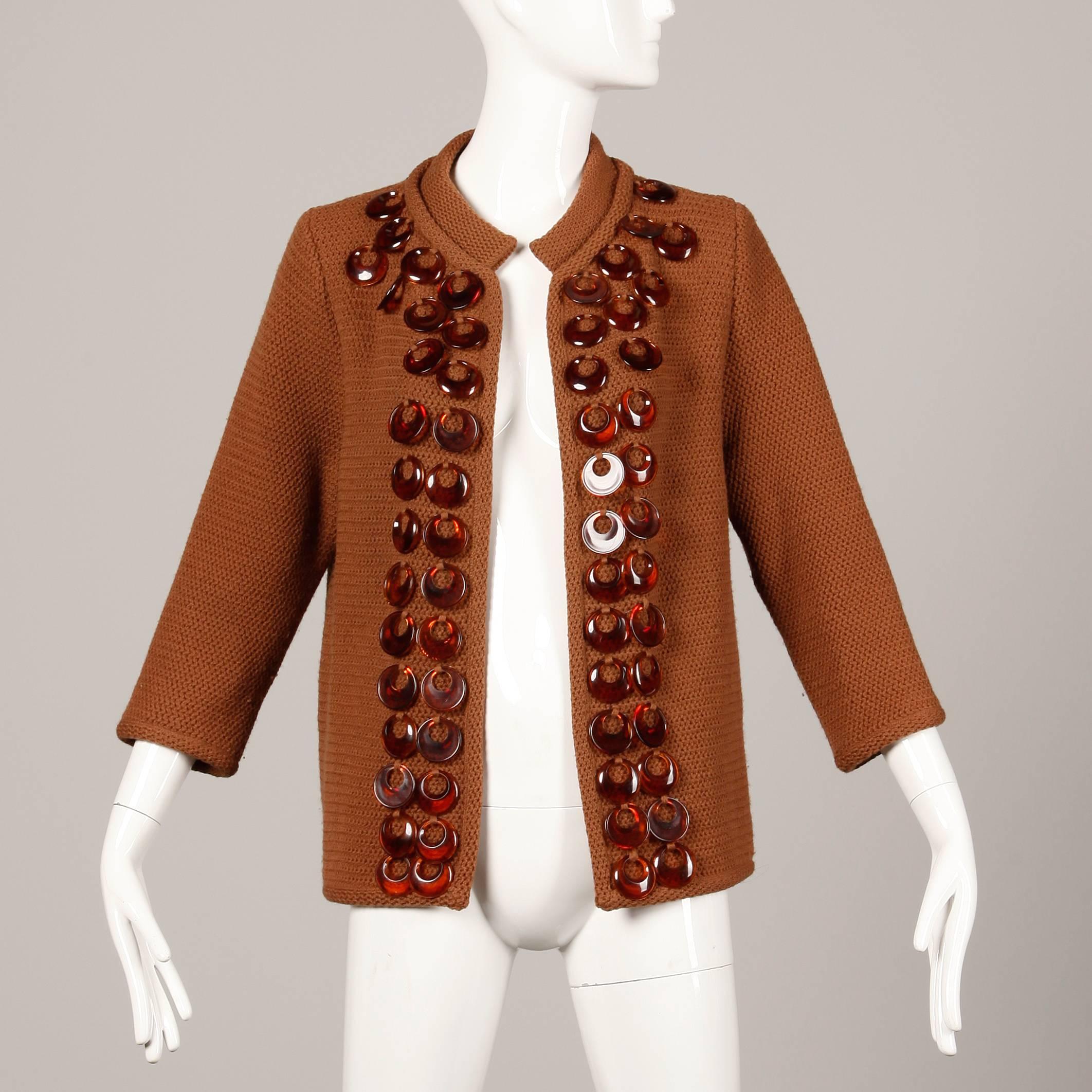 Vintage 1960s brown wool knit cardigan sweater with plastic rings by Ethel Beverly Hills. Unlined, no closure (hangs open). Fits like a modern size small-medium. The bust measures 40" (closed, unstretched), waist 38" (closed, unstretched),