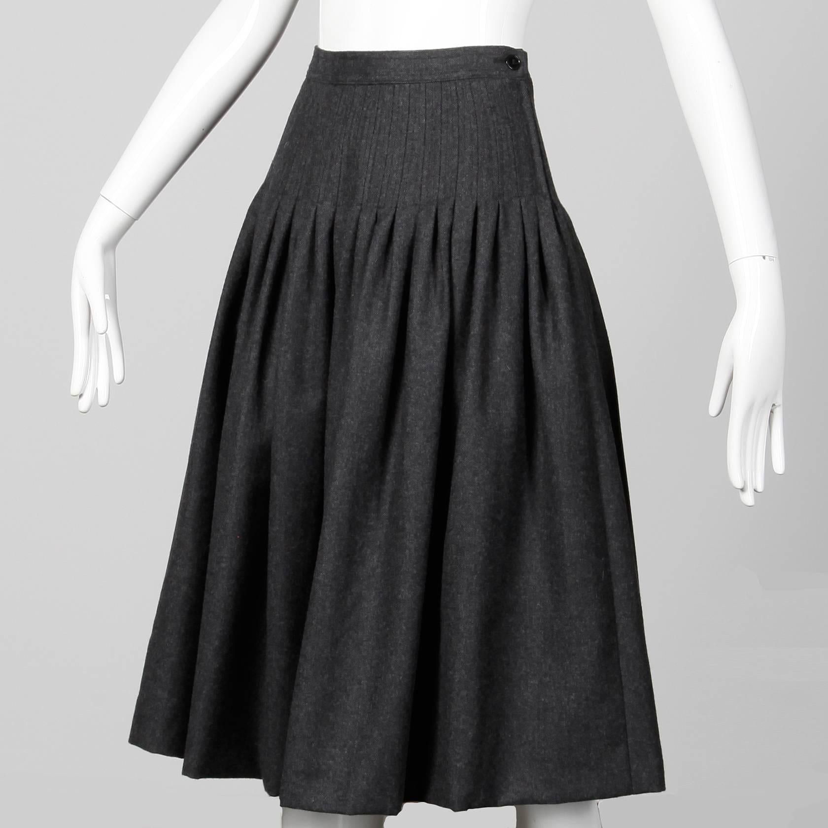 Vintage Valentino cashmere and wool blend gray fit and flare midi skirt. Unlined with side zip and button closure. The marked size is 44/ 10, but the skirt fits like a modern small-medium. The waist measures 27", hips up to 38" and the