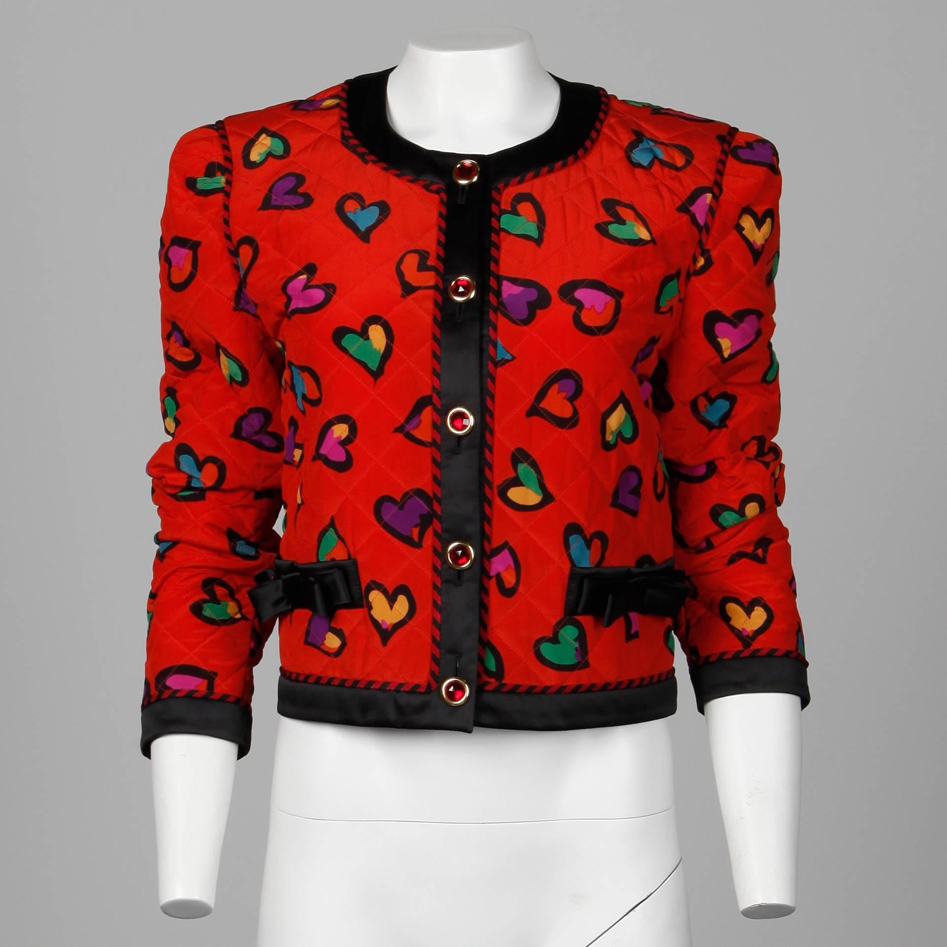 Vintage 1990s red silk Escada jacket with a darling heart print and red jewel buttons. Fully lined with front button closure. 100% silk. The marked size is 38. The bust measures 40", waist 36", shoulders 16", sleeve length 24",
