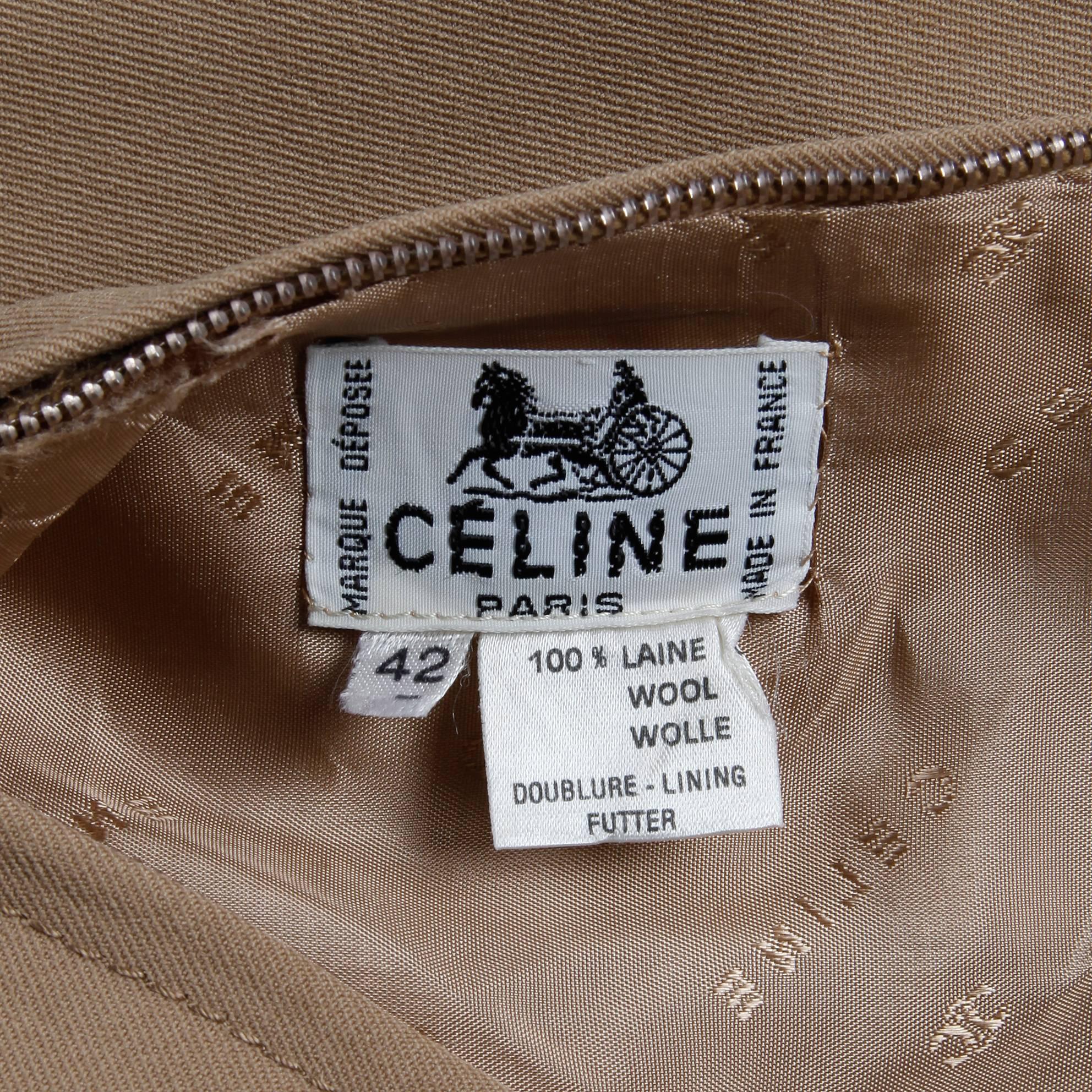Vintage 1970s brown pleated skirt with leather and goldtone Celine logo buckle by Celine Paris. Fully lined with rear metal zip and hook closure. 100% wool. The marked size is 42, and the skirt fits like a modern size small. The waist measures 26