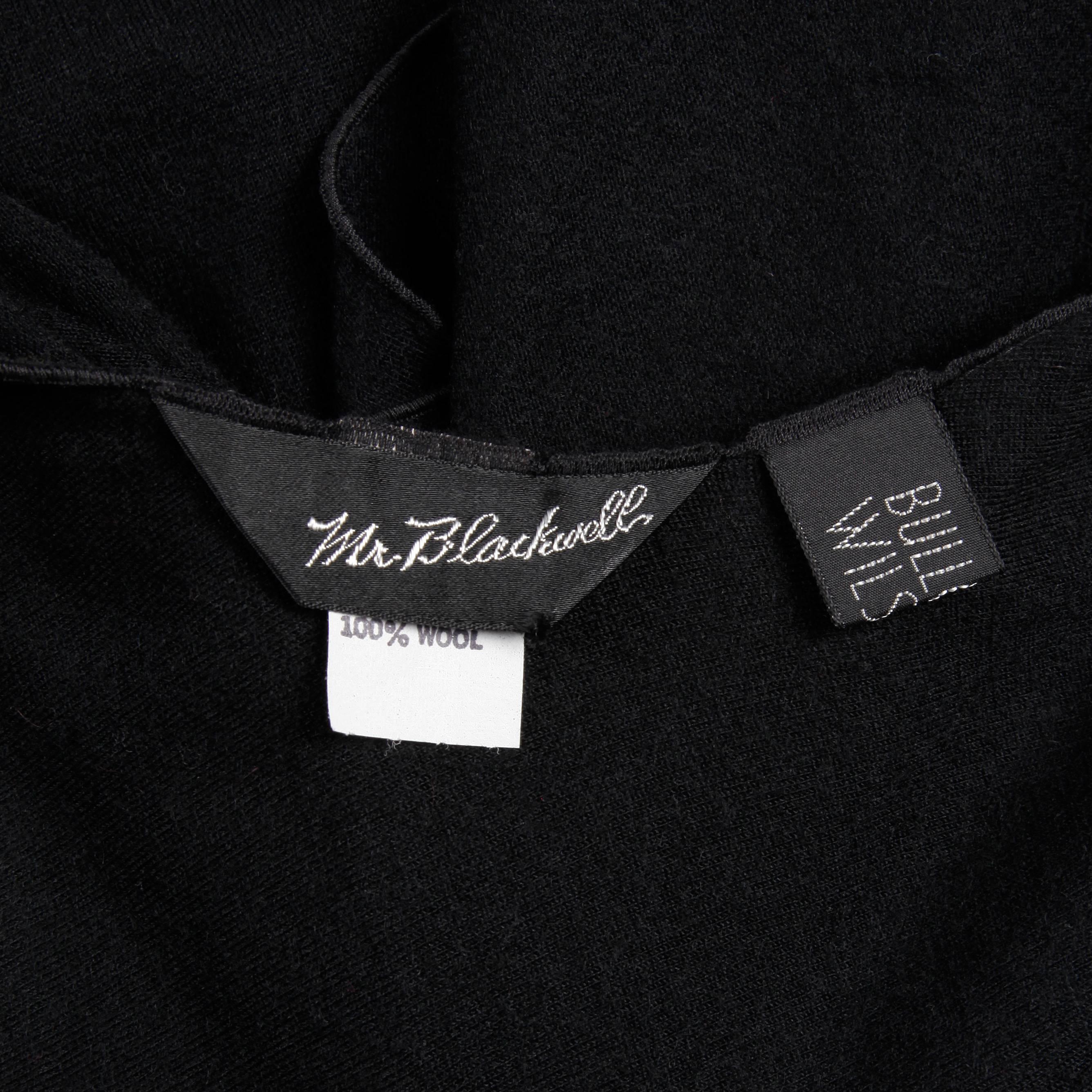 Light weight black wool wrap by Mr. Blackwell for Bullock Wilshire. Such a versatile piece! Unlined with no closure, hangs open.  100% wool. The total length is 30". Excellent vintage condition with no noted flaws. 