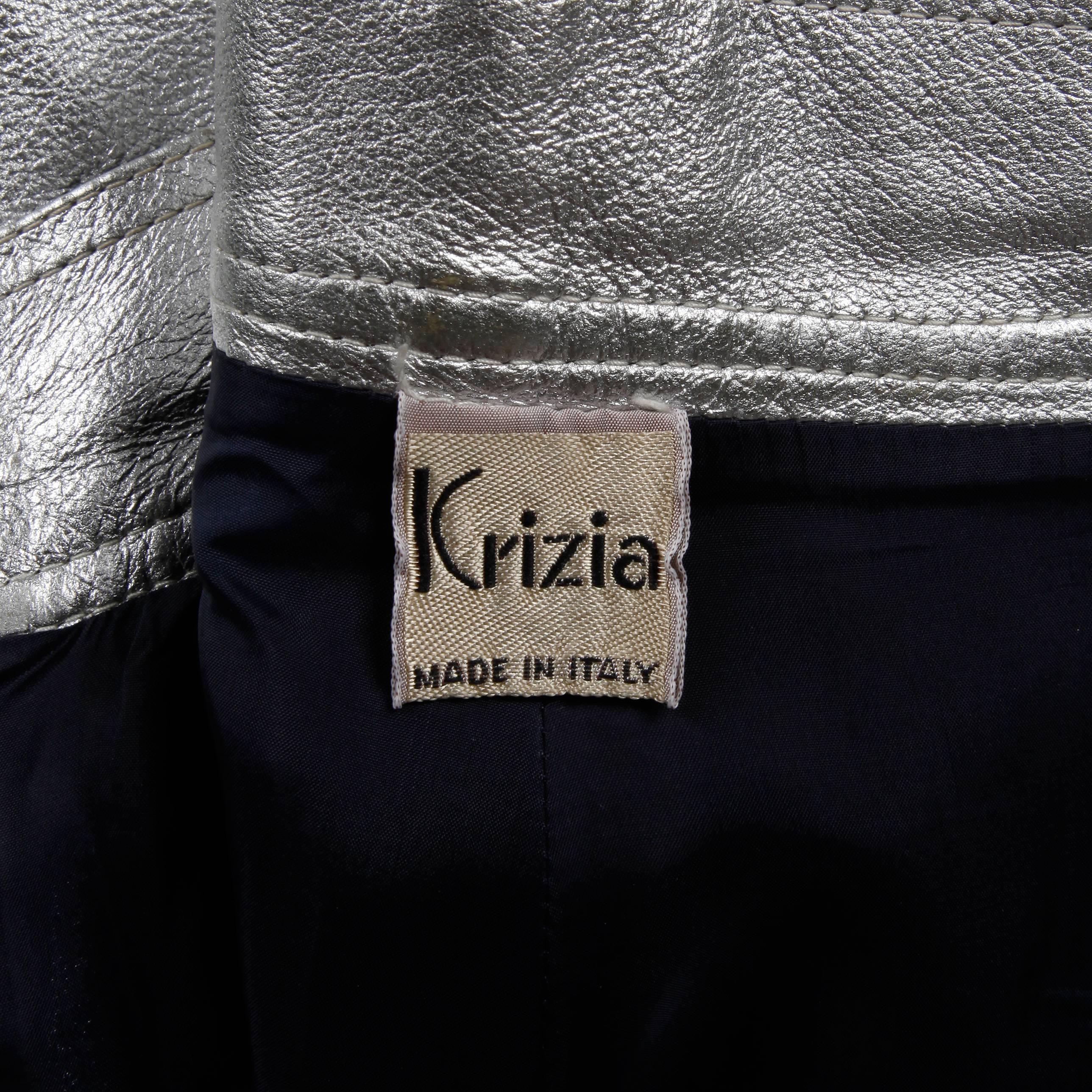 Vintage metallic silver genuine leather shorts by Krizia. Fully lined with front metal zip, button and belt closure. Side patch pockets and attached belt. Fits like a modern size small. The waist measures 25