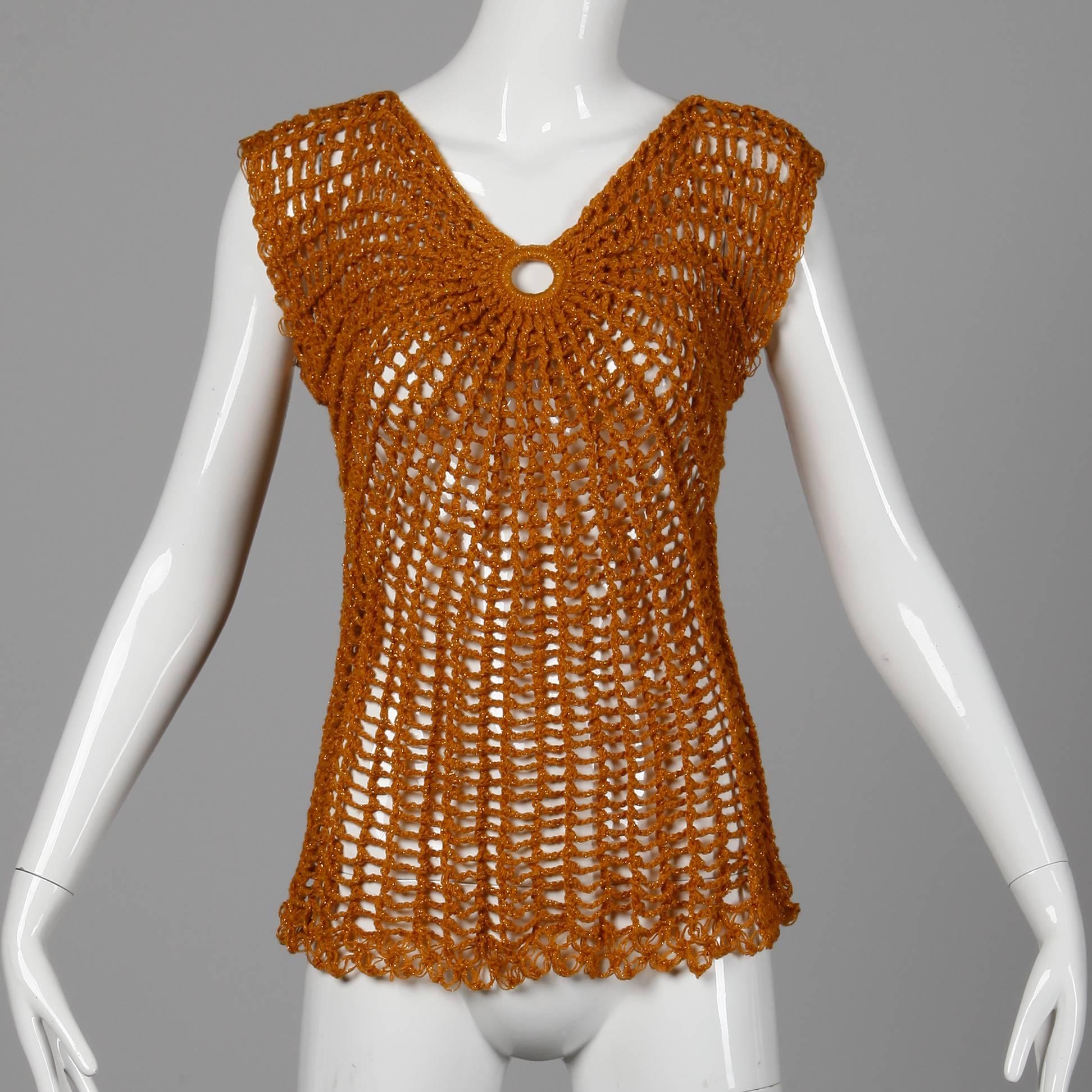 Hand done! This vintage metallic gold crochet sweater top is from the 1970s. Unlined with no closure (pulls on over the head). Fits like a modern size small-medium. The bust measures 30-38