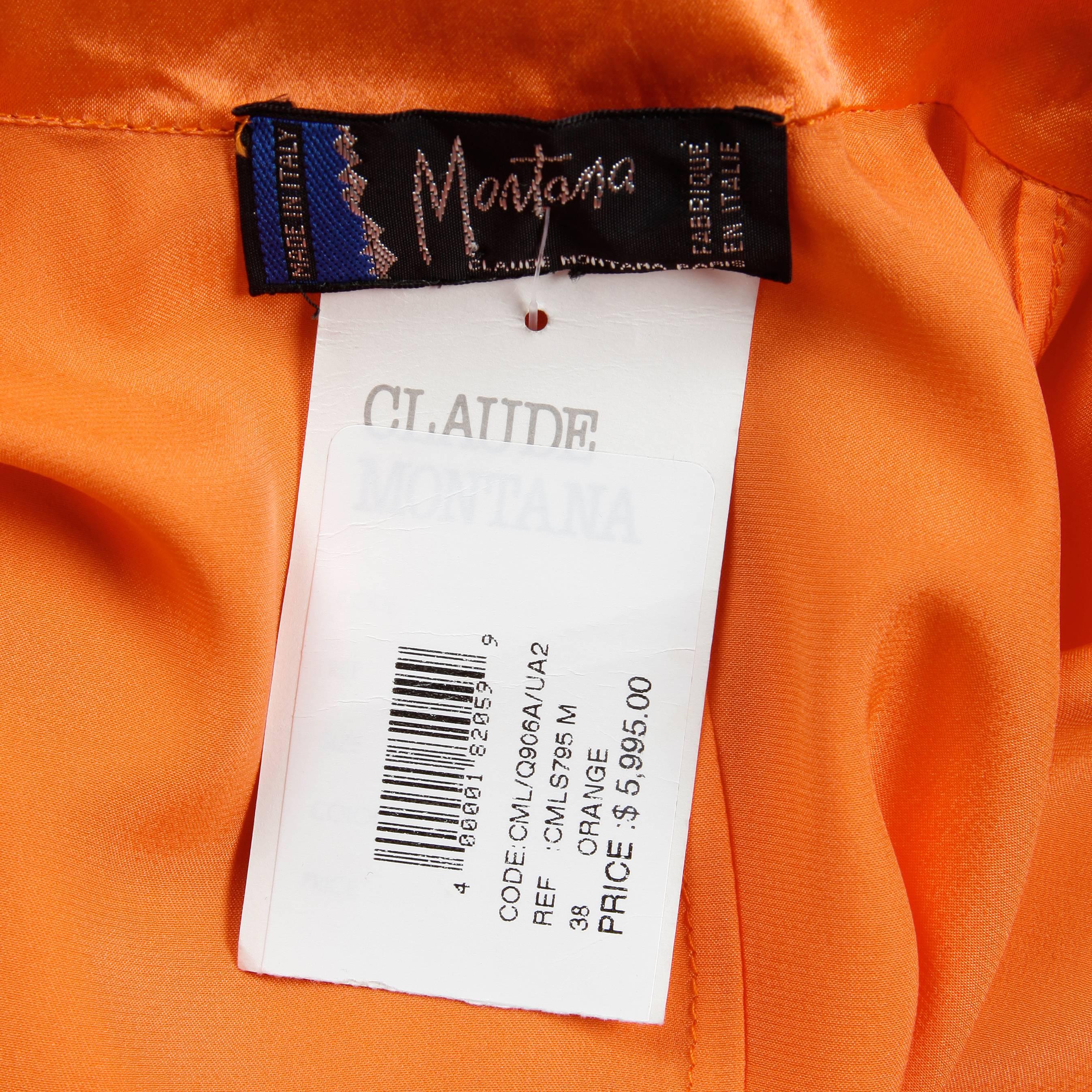 Gorgeous vintage bright orange silk blouse by Claude Montana with the original $5,995.00 tags attached in unworn condition. Unlined with front button, snap and tie closure, and button closure at the wrists. The marked size is 38, and the blouse fits