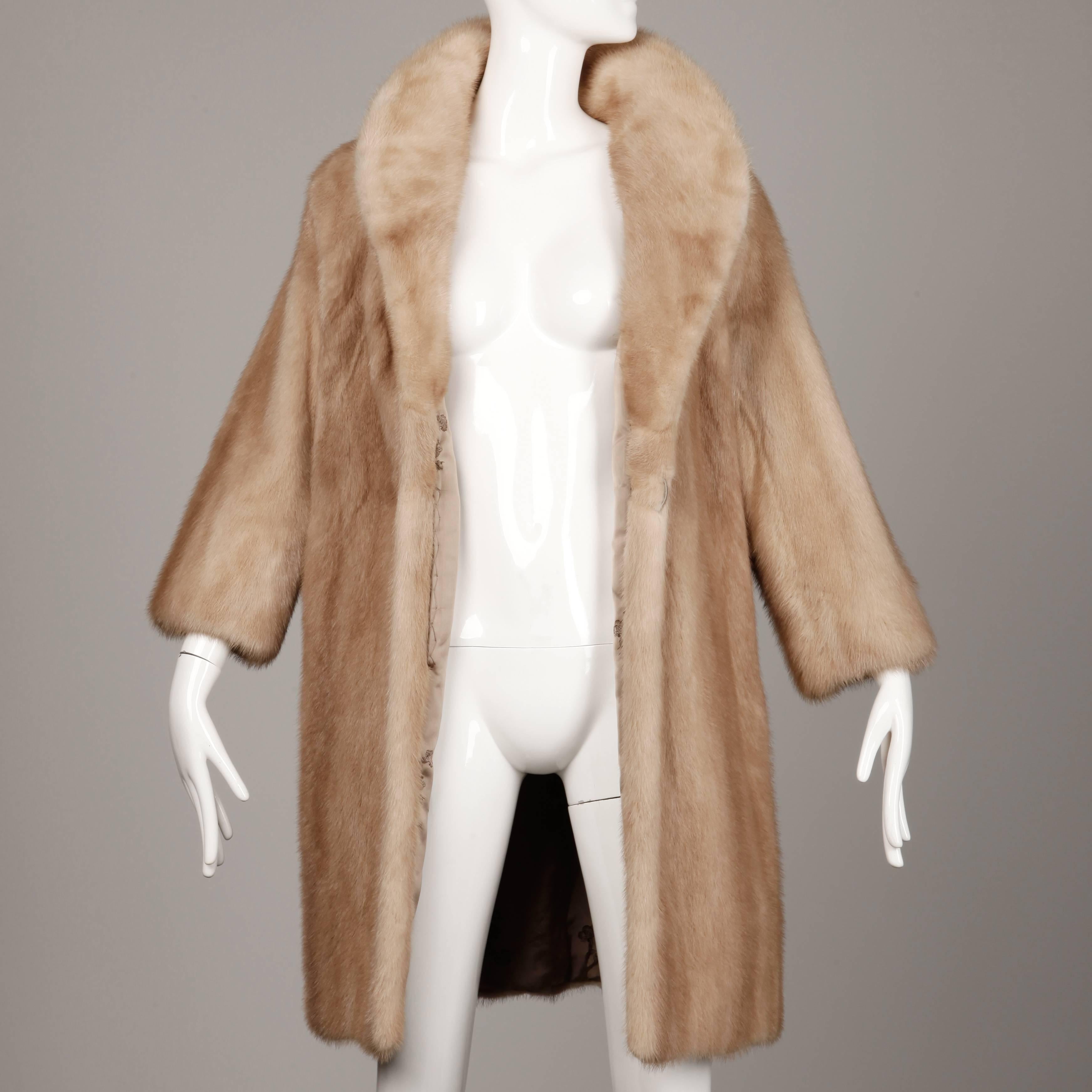 Simple and chic 1960s vintage autumn haze mink with a rounded pop up collar. Fully lined with hidden side pockets and button closure. Fits like a modern size medium. The bust measures 42