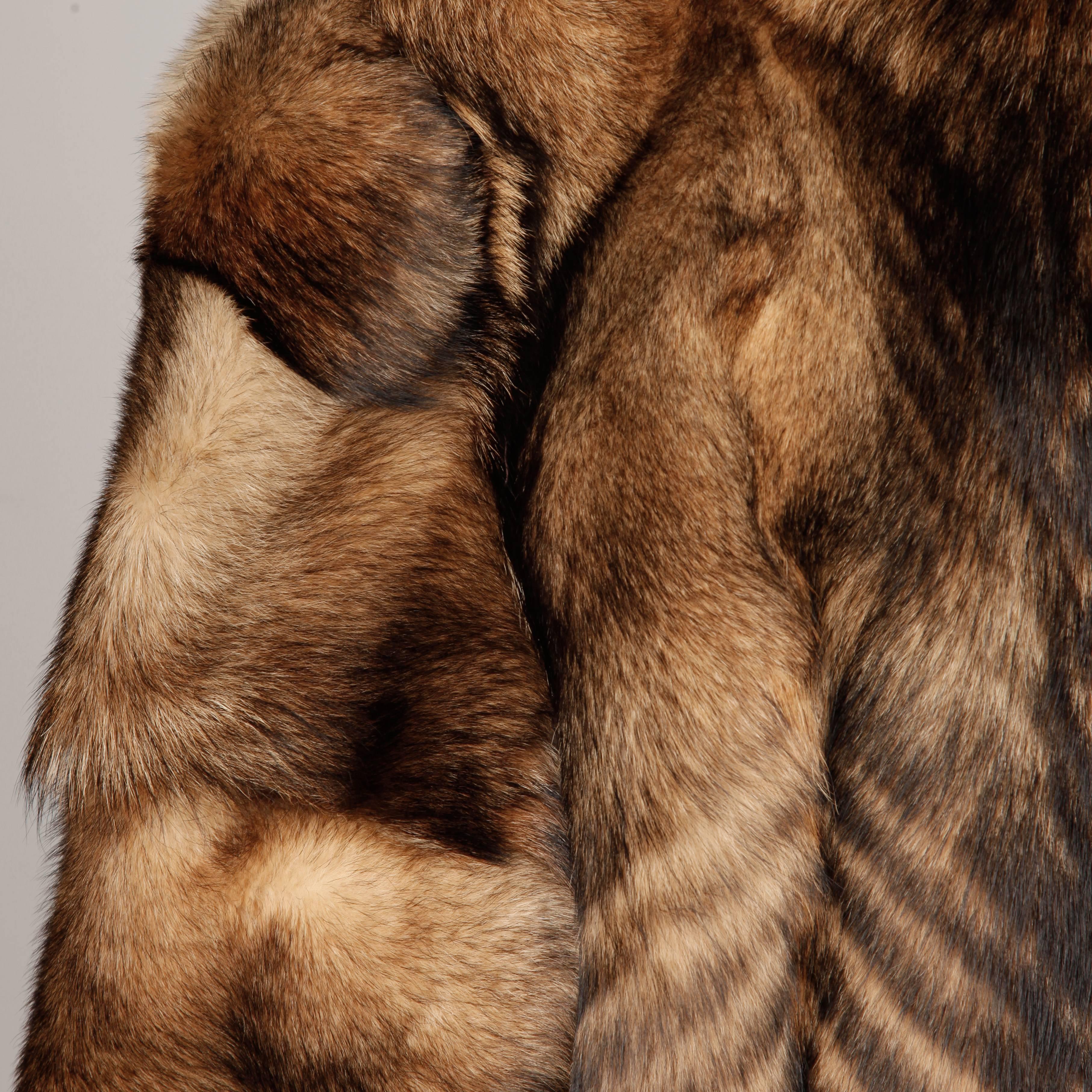 Stunning vintage wolf fur coat feathered in a chevron design along the bottom portion. Full sleeves and gorgeously matched pelts. Fully lined with front hook closure. Unisex cut fits like a women's large/ men's medium. The bust measures 42