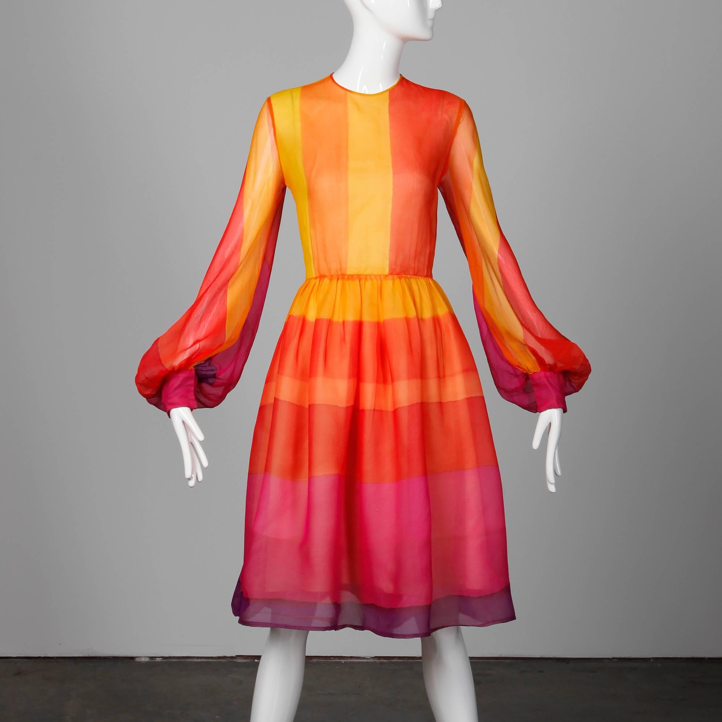 Vibrant vintage silk dress by Kiki Hart for Neiman-Marcus. Partially lined with rear zip and hook closure and snap closure at wrists. Fits like a modern size small. The bust measures 36