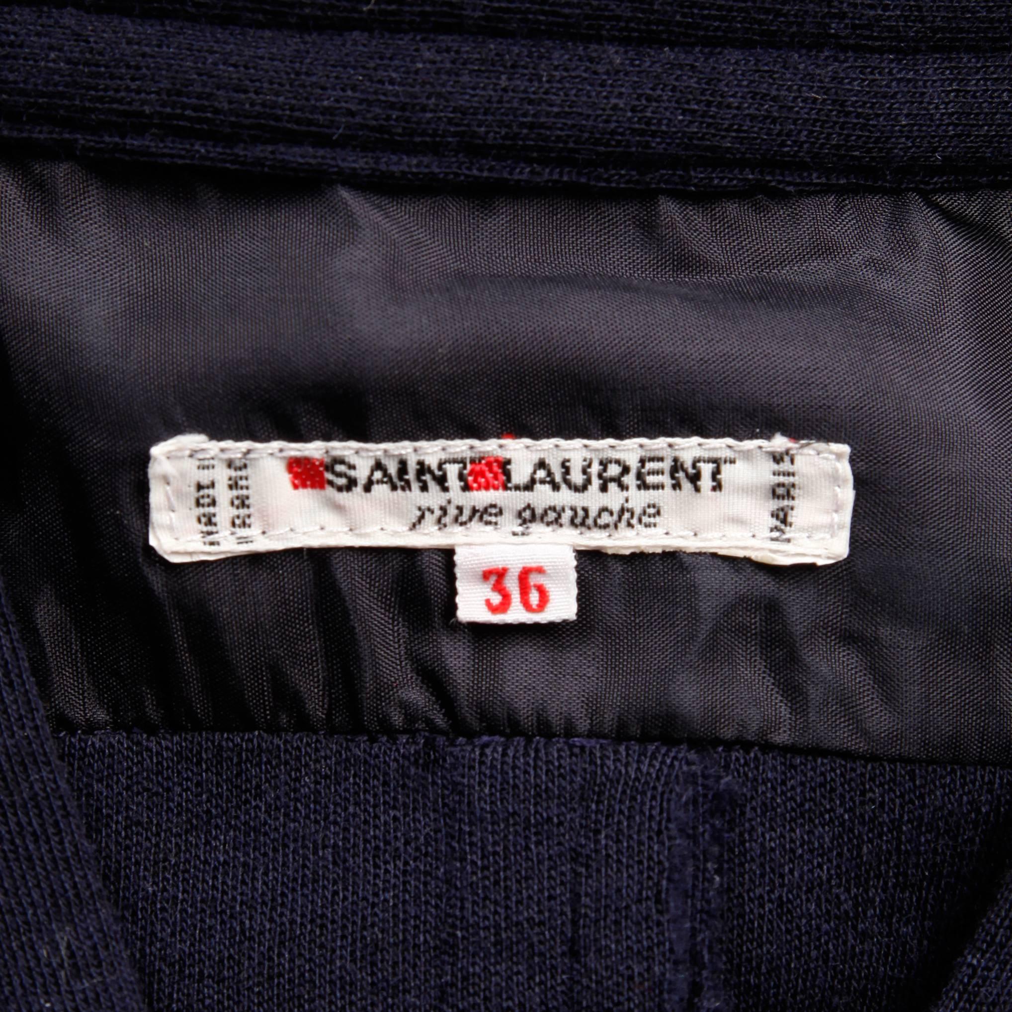 Vintage Saint Laurent pullover wool knit sweater in navy blue. Unlined with no closure (pulls on over the head). Hidden side pockets. The marked size is 36, but this will likely fit a small-large due to its oversized shape. The bust measures 46