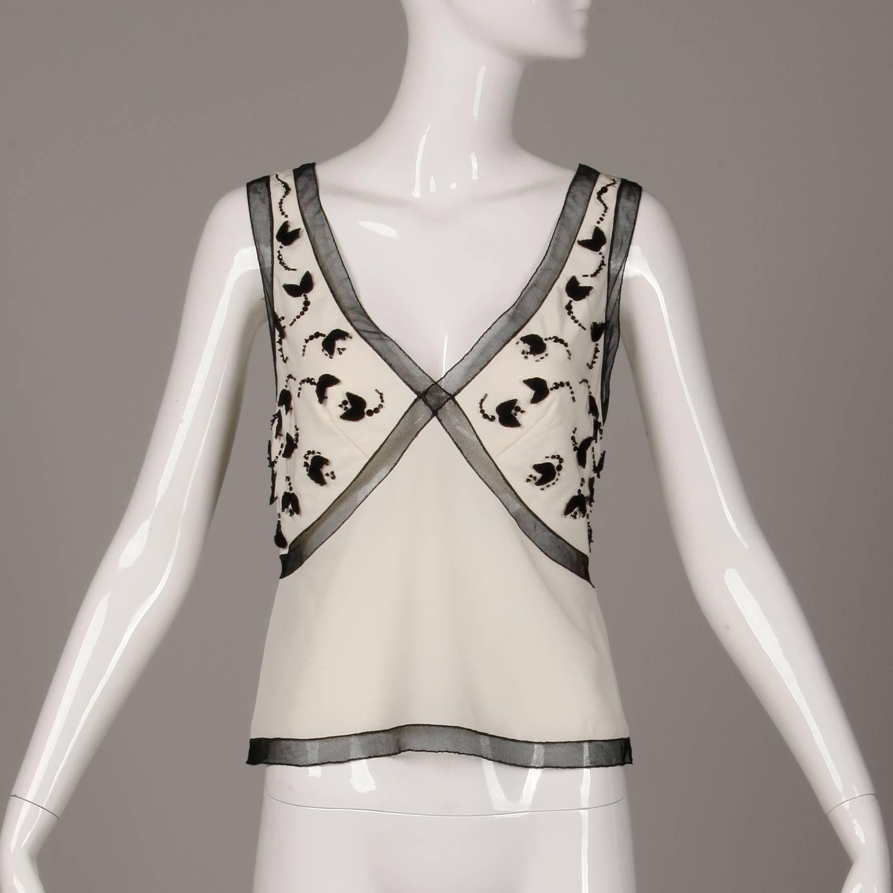 Versatile silk tank by Prada with black mesh, and beaded embellishment. Unlined with side zip and hook closure. The marked size is 42. 100% silk. The bust measures 35", waist 30" and the total length 20.5". Excellent vintage condition