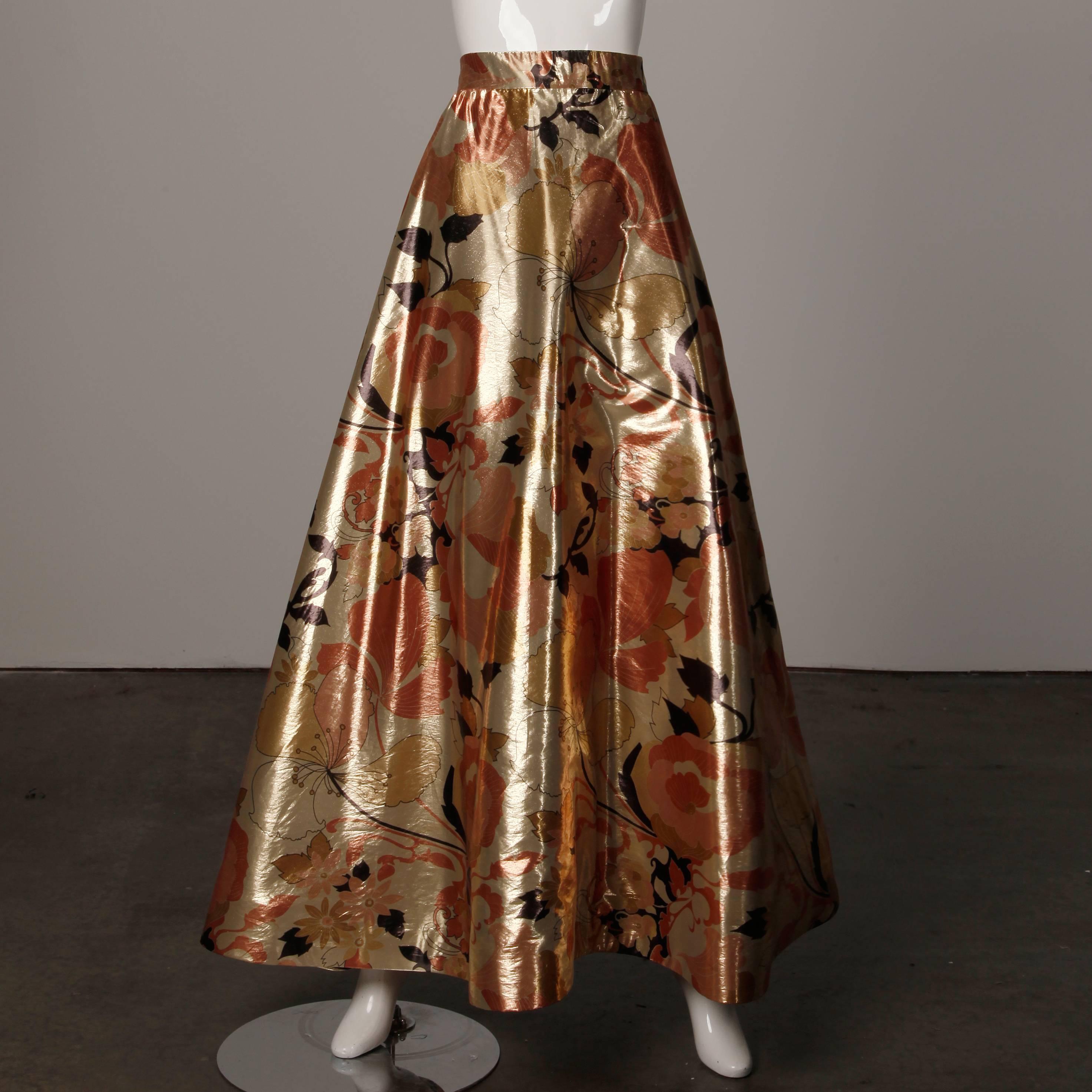 Stunning vintage 1970s 2-piece evening dress ensemble by Arnold Scaasi in metallic gold printed silk lamé. This ensemble fits like a modern size XS. The top is fully lined with rear zip and hook closure. Boning in back. The bust measures 32