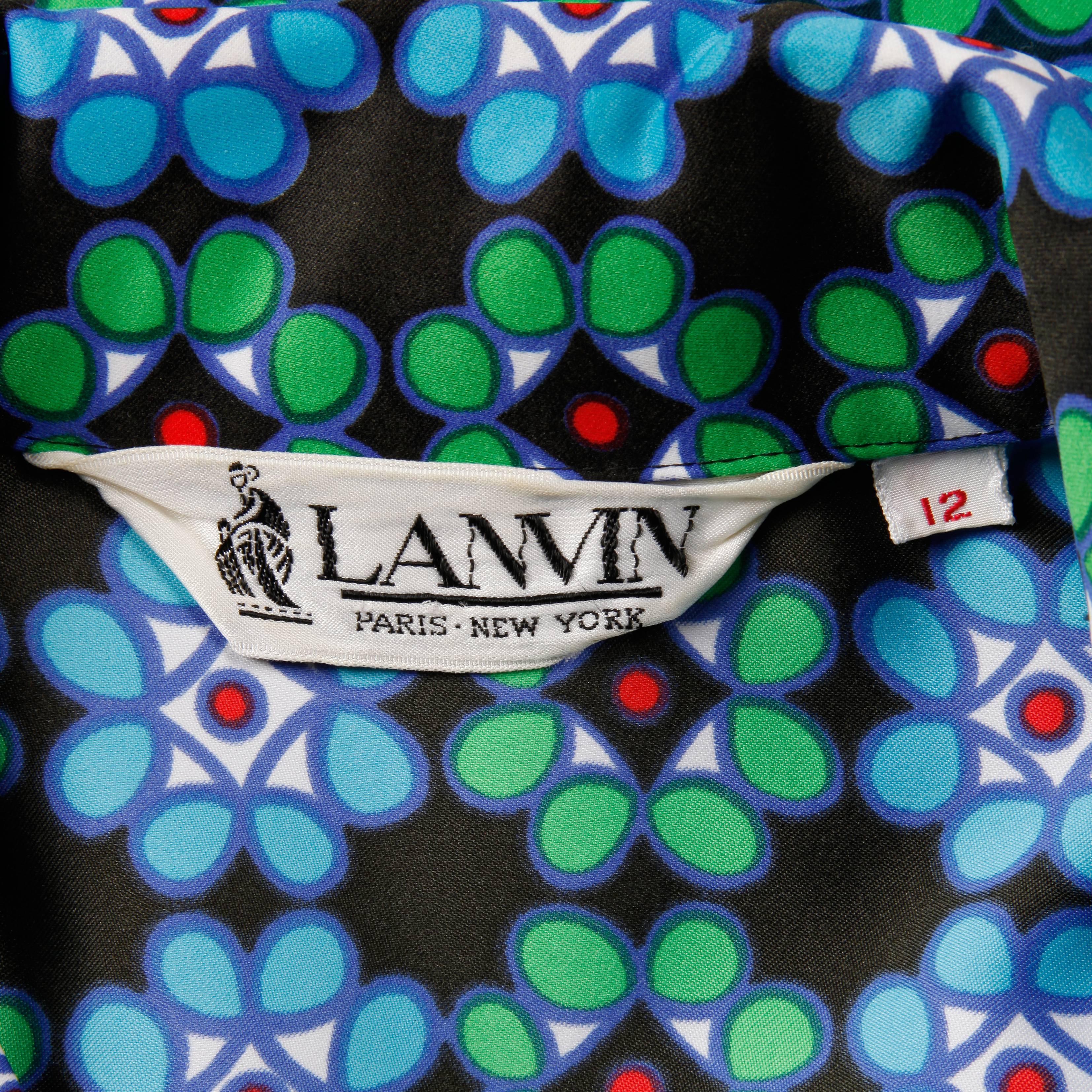 Incredible 1970s vintage shirt dress by Lanvin with a colorful geometric op art print. Unlined with front button closure and tie belt at waist. The marked size is 12, and the dress fits like a modern size large. The bust measures 39