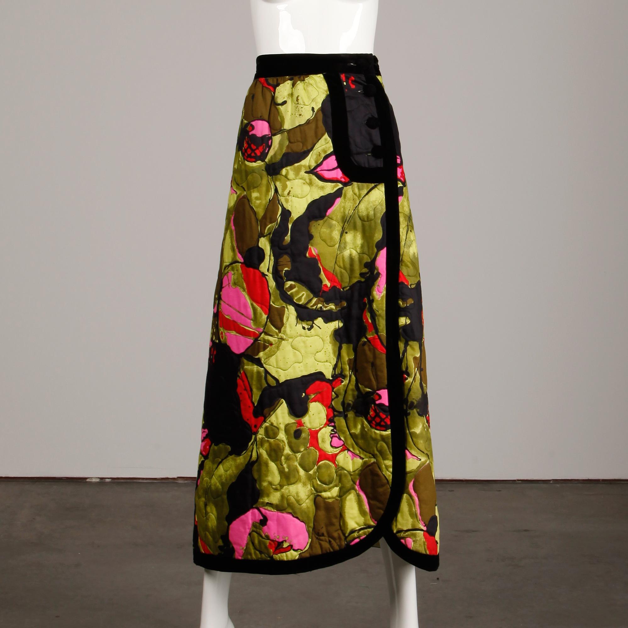 Vintage 1970s maxi skirt in green, black, pink and red quilted silk with black velvet trim by Dynasty. Fully lined with side button and hook closure. The marked size is 10, but the skirt fits like a modern medium. The waist measures 28