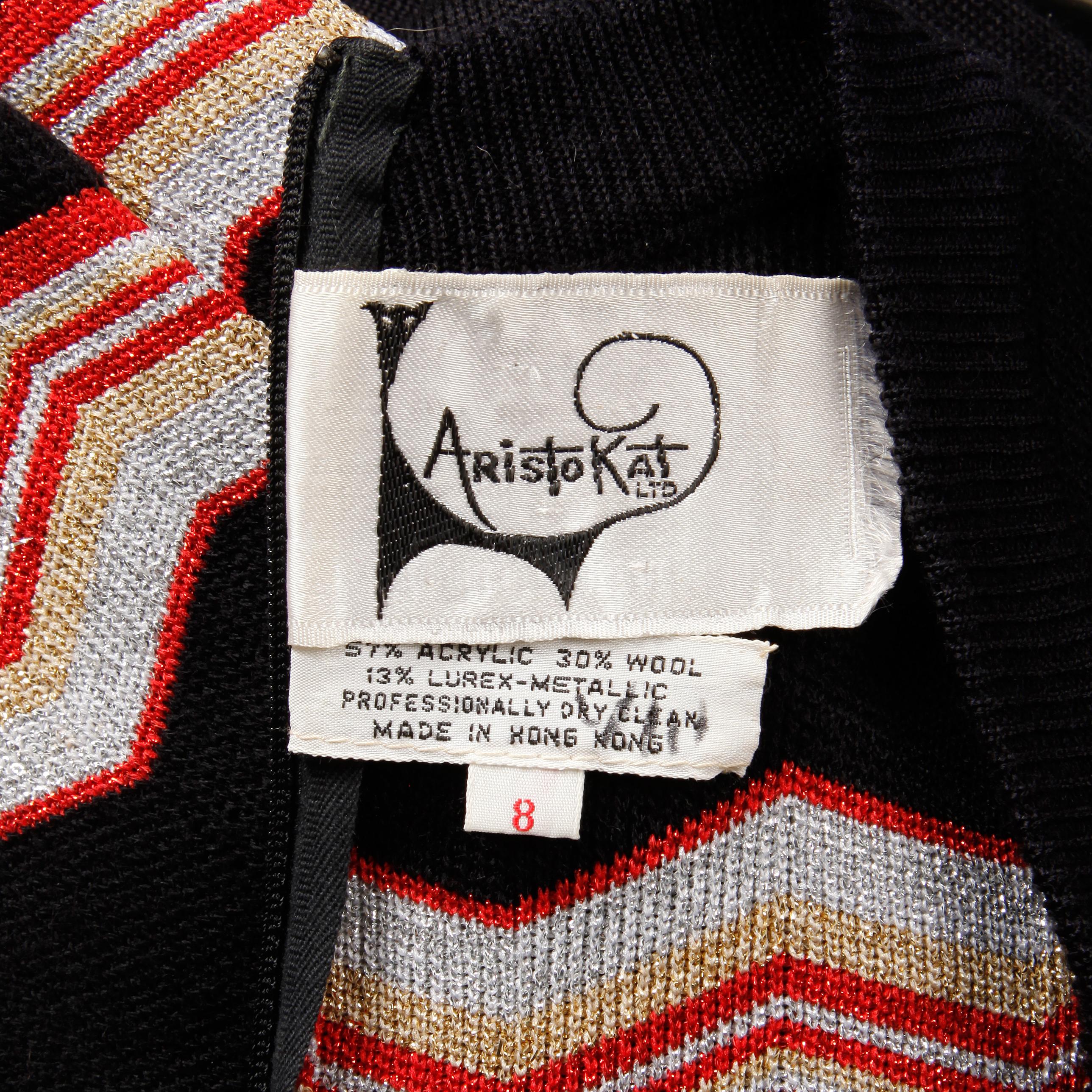 Vintage 1970s maxi dress with a zig zag design in red, metallic silver, metallic gold, and black knit by Aristo Kat. Unlined with rear zip closure. 57% acrylic, 30% wool, 13% lurex-metallic. The marked size is 8, but the dress fits more like a