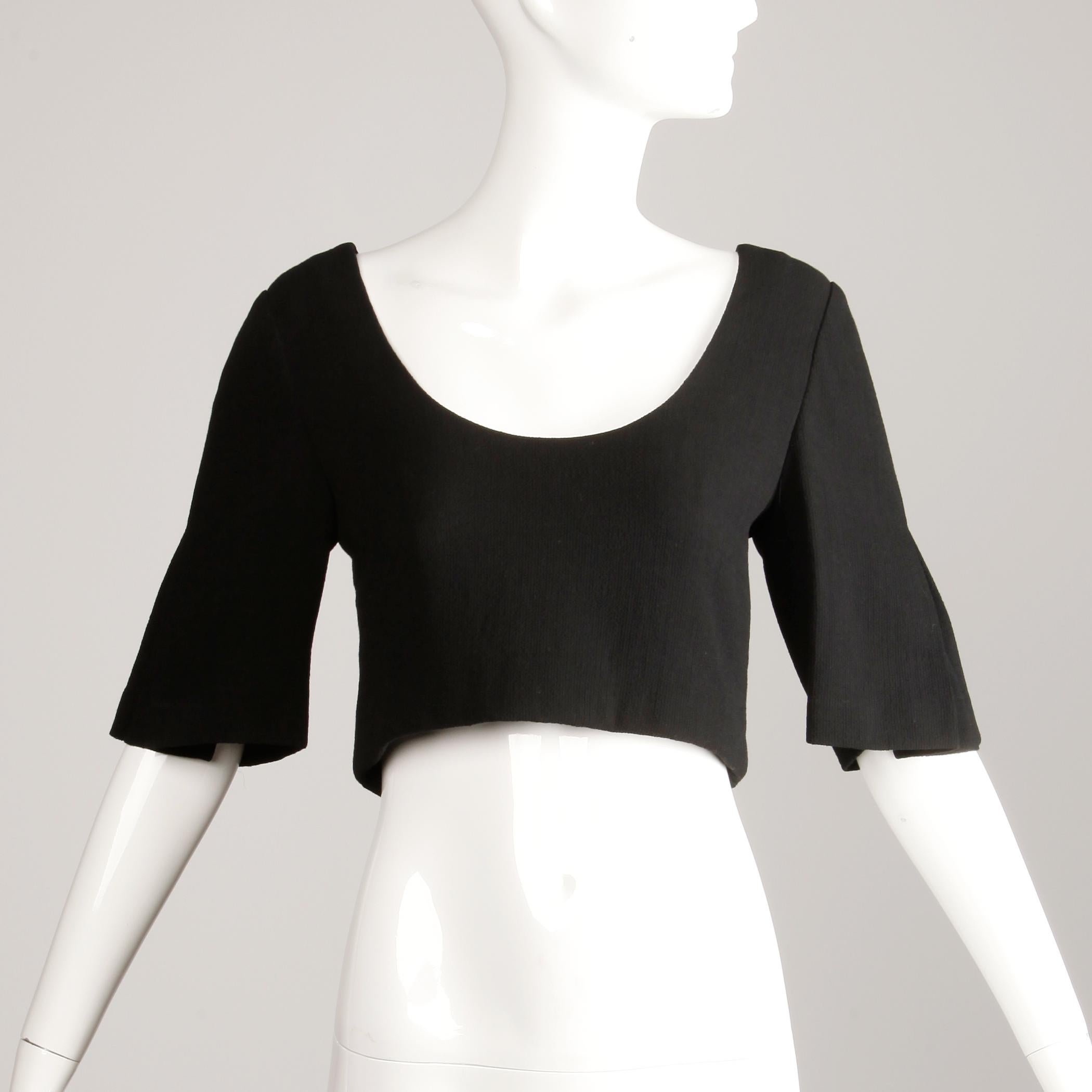The perfect little black top! Vintage black wool crepe cropped top with 3/4 pleated bell sleeves by James Galanos. Unlined with rear button and snap closure. Fits like a modern size small. The bust measures 34