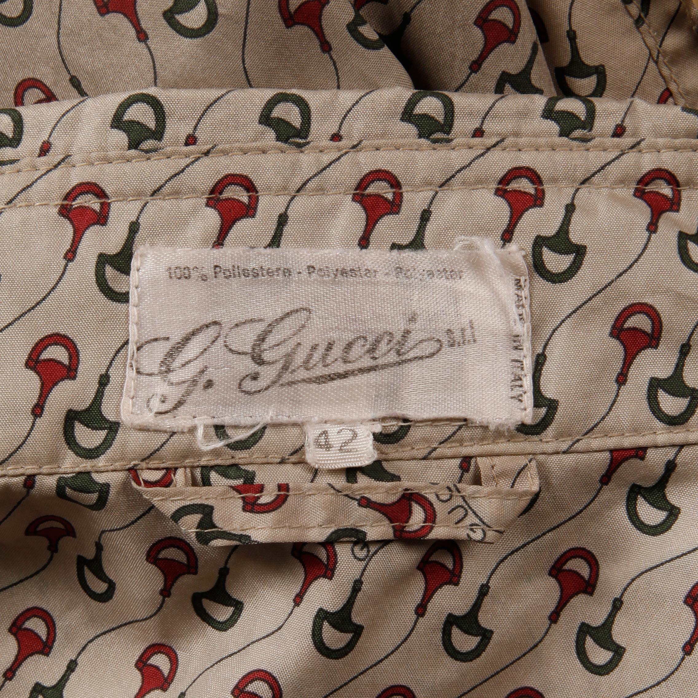 Vintage 1970s Gucci raincoat or duster with iconic Gucci horse bit and monogram print. This would look also look great belted! Unlined with front button closure. Front patch pockets. The marked size is 42 and the coat fits like a modern size