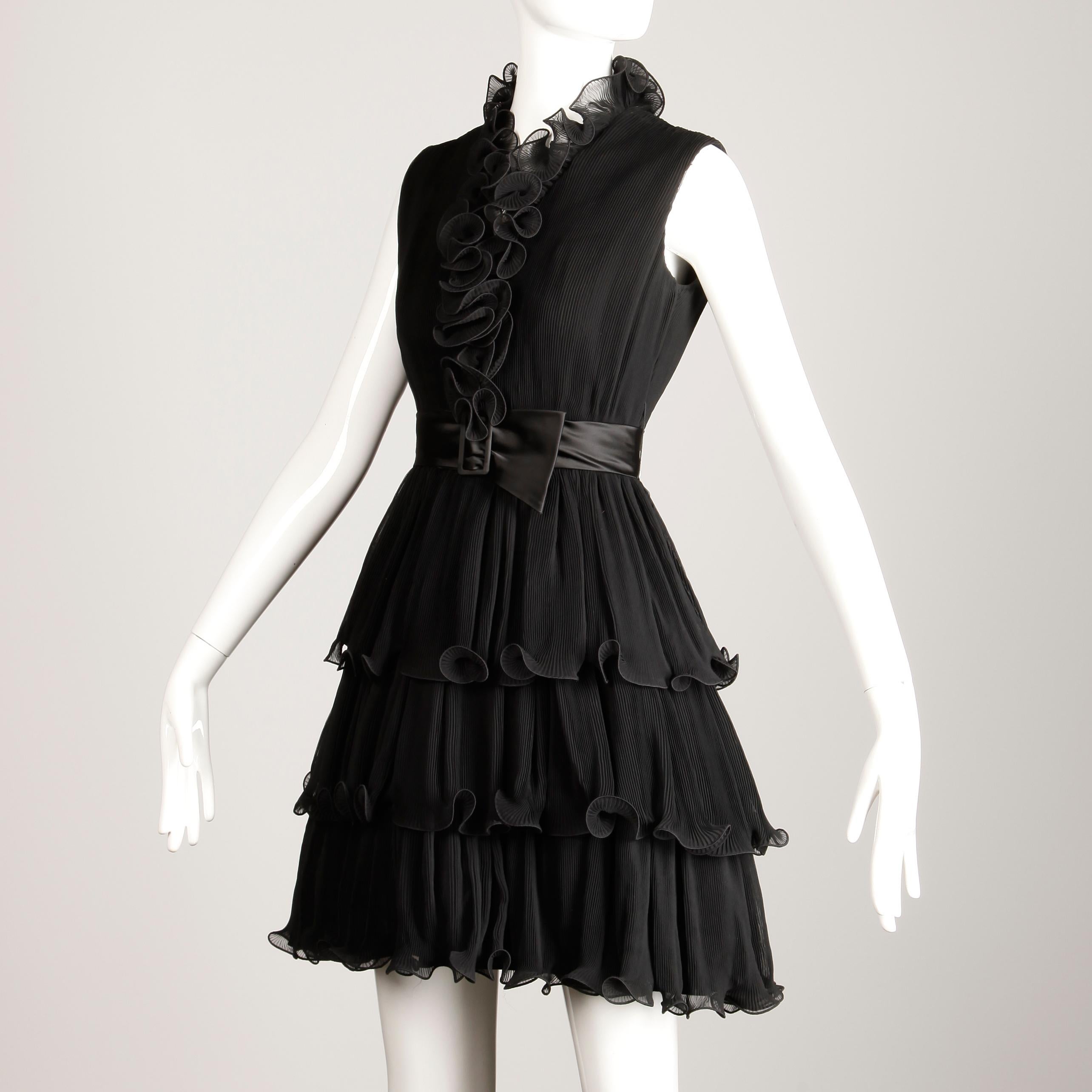 Darling vintage black Emma Domb cocktail dress with ruffled micro pleats from the 1970s. Fully lined with rear zip, snap, and hook closure and tie closure on the tulle lining. The marked size is 7, but the dress fits more like a modern XS. The bust