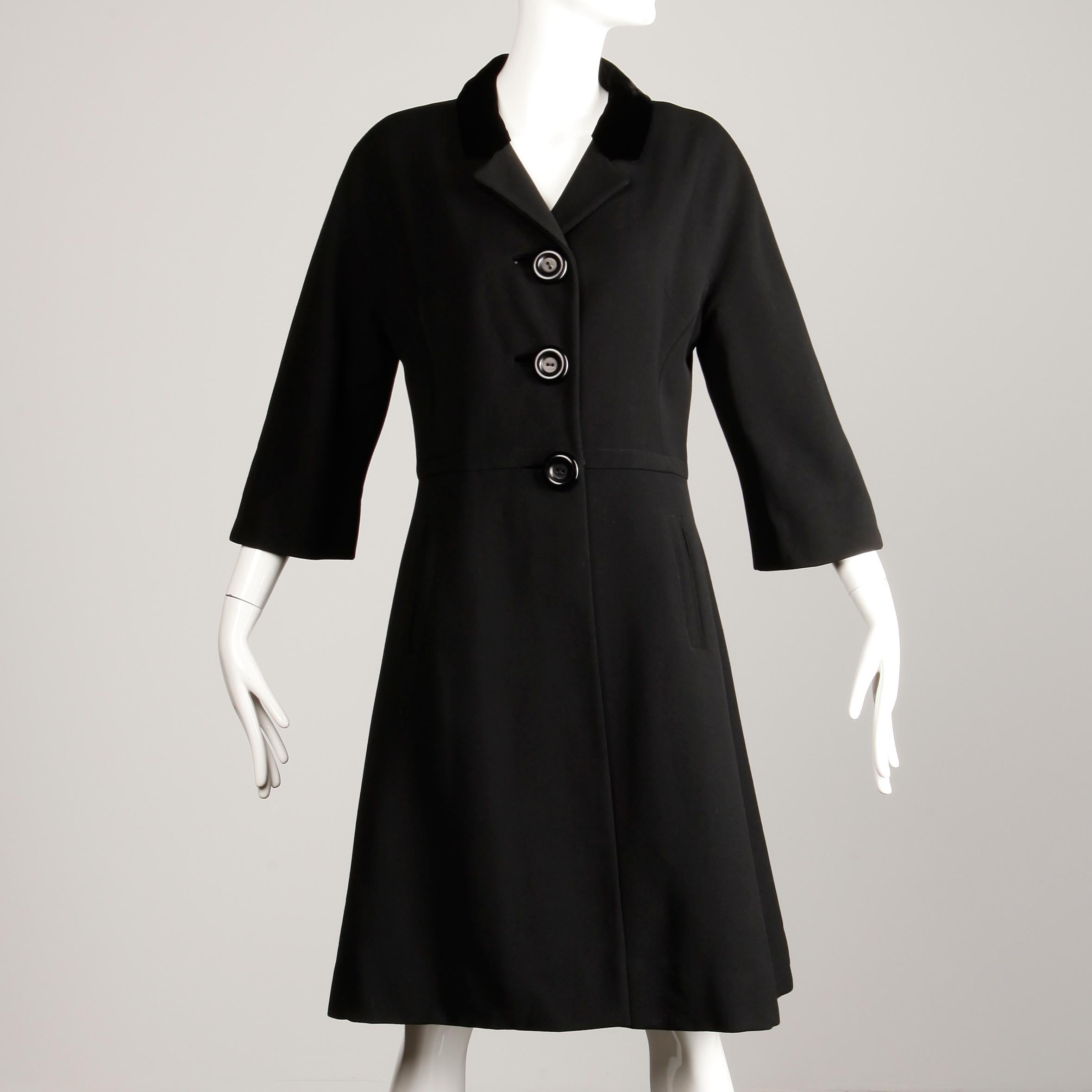 Vintage 1960s black wool mod coat with 3/4 length cropped sleeves. Fully lined with front button and snap closure. Fits like a modern size medium. The bust measures 38