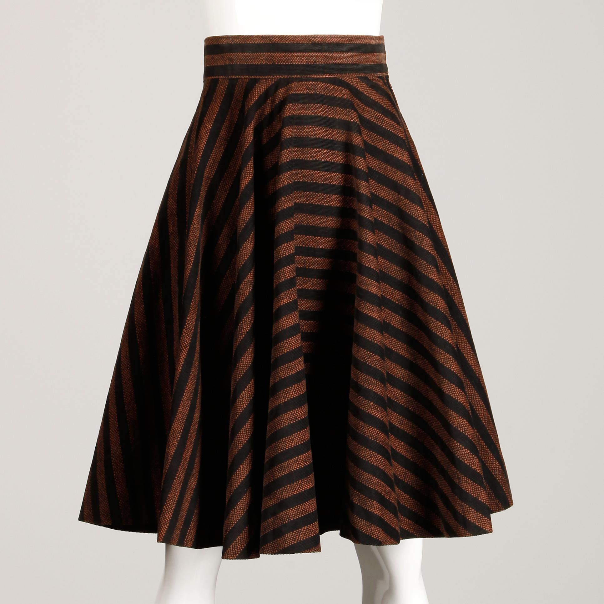 Vintage 1950s circle skirt in a brown and black striped corduroy style fabric. Unlined with side metal zip and hook closure. Fits like a modern XS. The waist measures 22