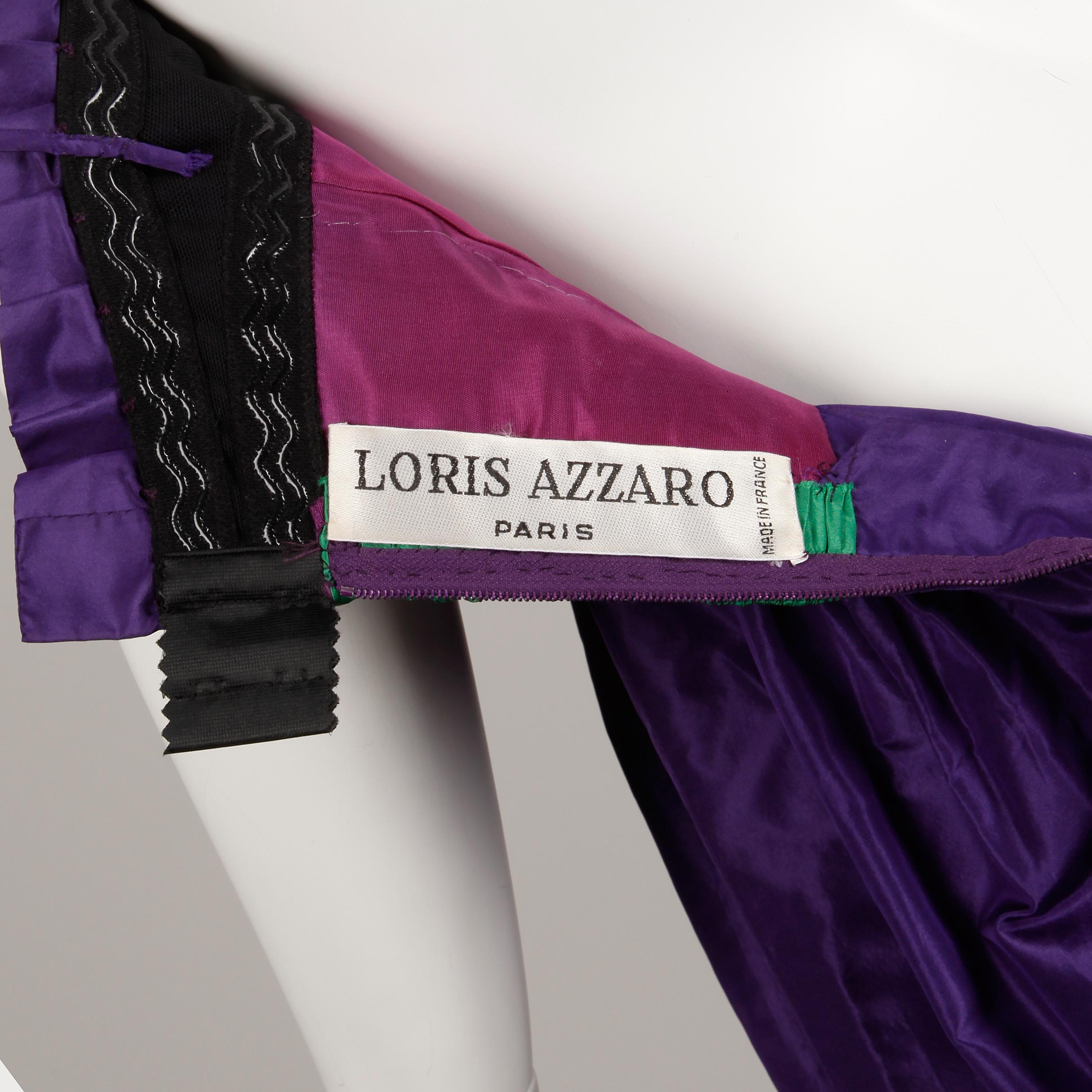 Beautiful vintage evening gown by Loris Azzaro in a deep purple silk taffeta fabric with a green silk taffeta empire waist detail. Partially lined with rear zip and hook closure. Built in underwire bra. Fits like a modern size XS-S. The bust
