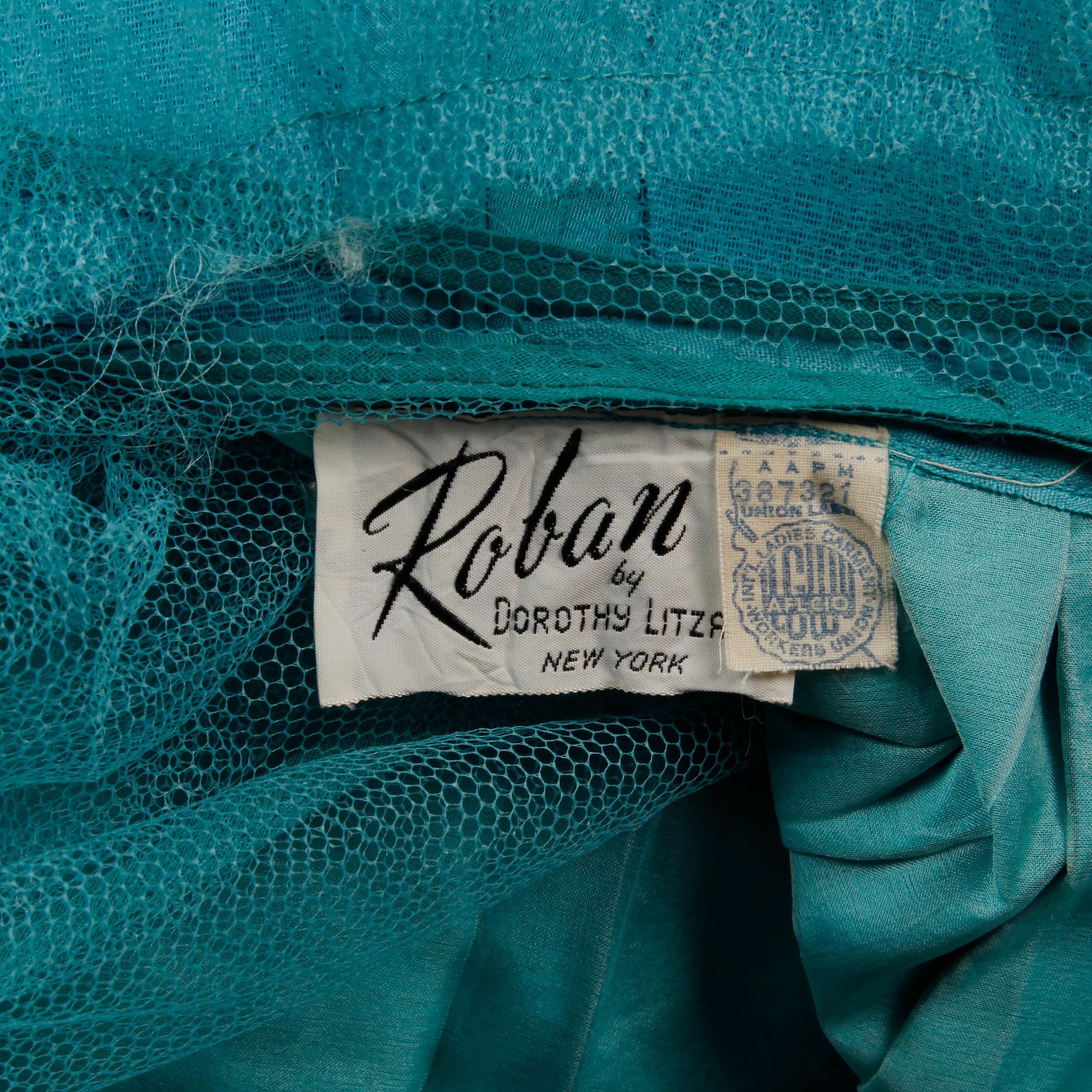 Stunning vintage robin's egg blue silk taffeta cocktail dress with a scoop neck, chantilly lace and tulip hem by Dorothy Litzan for Roban. Partially lined with rear metal zip and hook closure. Fits like a modern size XS. The bust measures 36