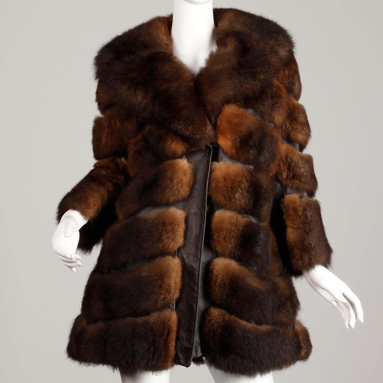So soft and full! This 1970s vintage brown opossum fur coat is unbelievably soft. It features leather trim and a chevron design. Fully lined with front hook closure. Hidden side pockets. Fits like a modern size small-medium. The bust measures 41