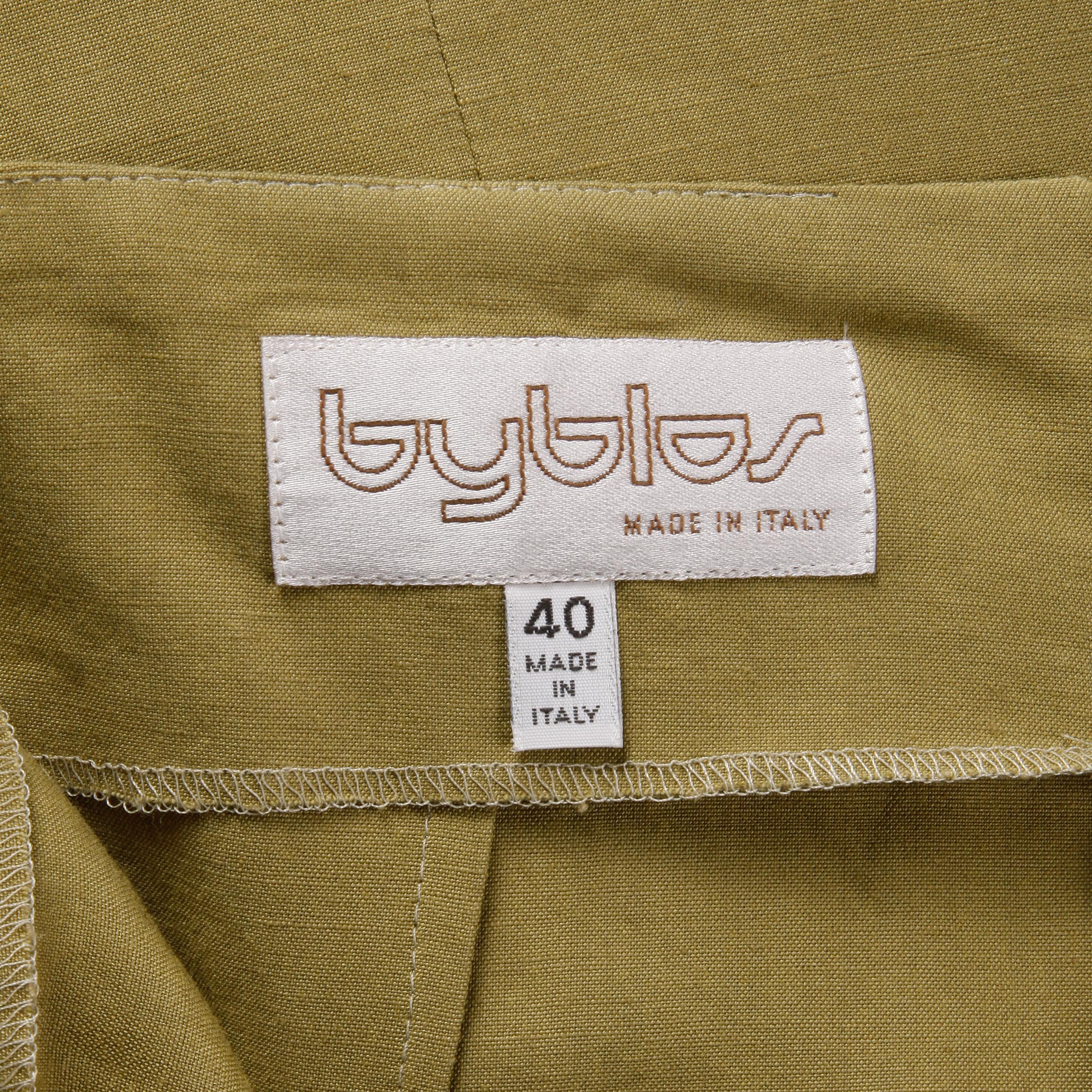 Flattering vintage olive green 1990s asymmetric skirt by Byblos in what feels like a stretch linen fabric. Unlined with rear zip closure. The marked size is 40, and the skirt fits like a modern size small. The waist measures 26