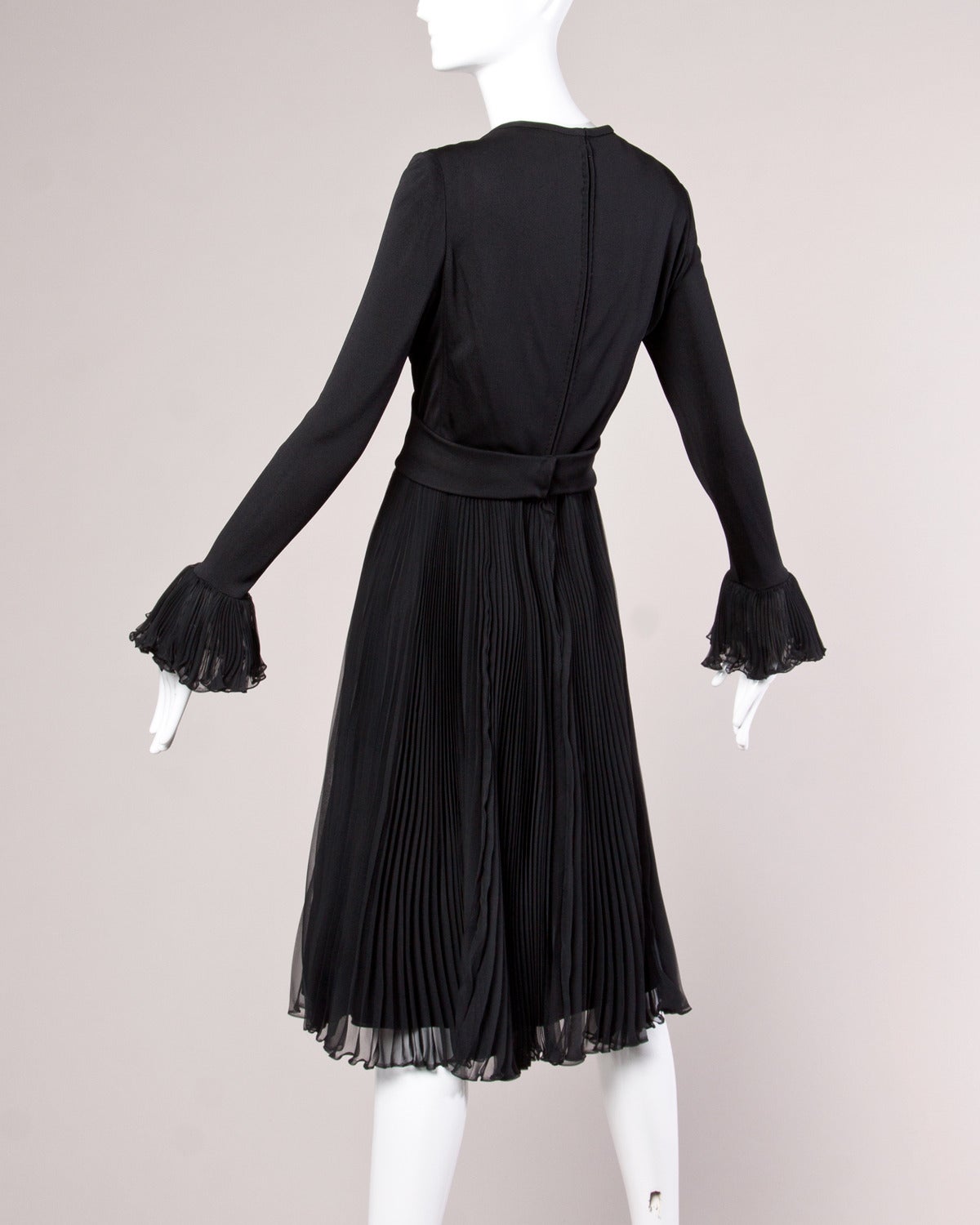 Gorgeous high end couture dress dated August 12, 1970 by Ric McClintock. Bodice is made up of what feels like silk jersey. Sheer accordion pleated skirt and sleeve cuffs. Heavy weight circular rhinestone belt buckle detail. A rare and hard-to-find