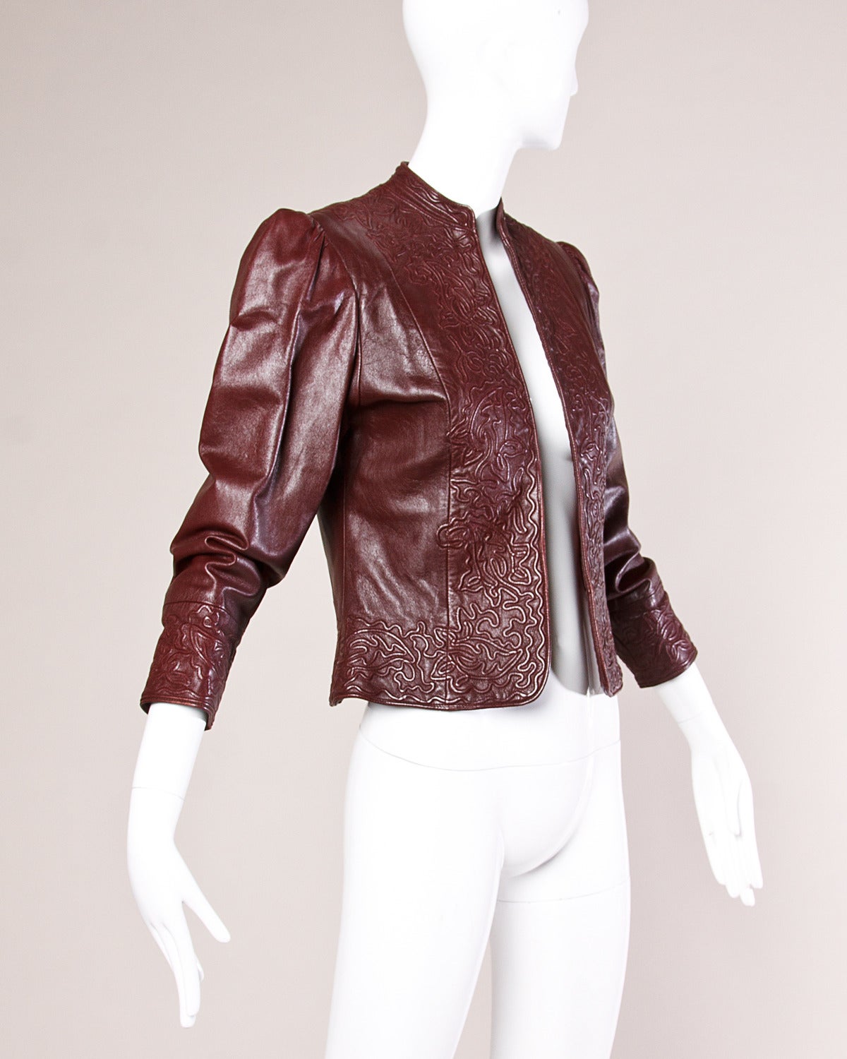 Gorgeous vintage burgundy leather jacket with a stitched embossed design. Sleek silhouette with full sleeves and gathered shoulders. Label has a hand written number tag.

Details:

Fully Lined
Structured Shoulder Pads Sewn Into Lining
No