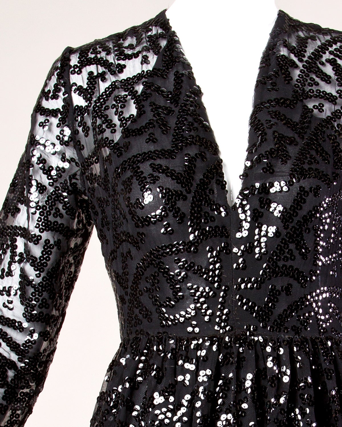 Vintage black sequin maxi dress by Evelyn Byrnes. Sheer sleeves with zip up cuffs.

Details:

Partially Lined
Hand Sewn Black Sequins
Sheer Sleeves
Rear Zip Closure
Marked Size: Not Marked
Estimated Size: Medium
Color: Black
Label Evelyn