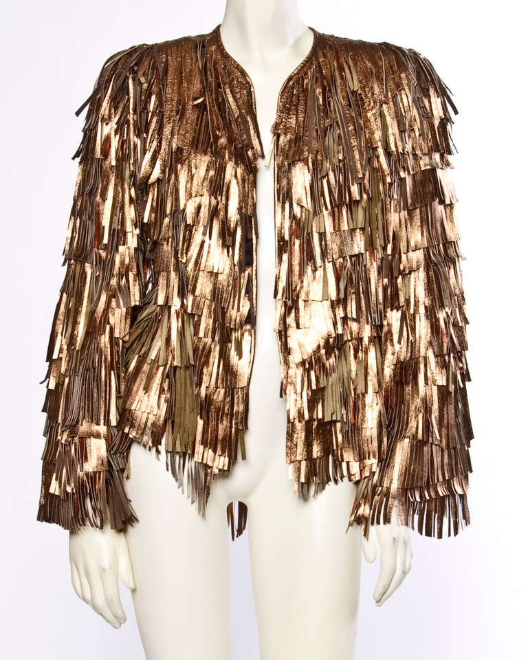 Hand cut metallic rose gold leather fringe jacket and and skirt set. Perfectly imperfect allover fringe. The jacket hangs open and has no closure with shoulder pads sewn into the lining. The skirt has an elastic waistband (please note that the