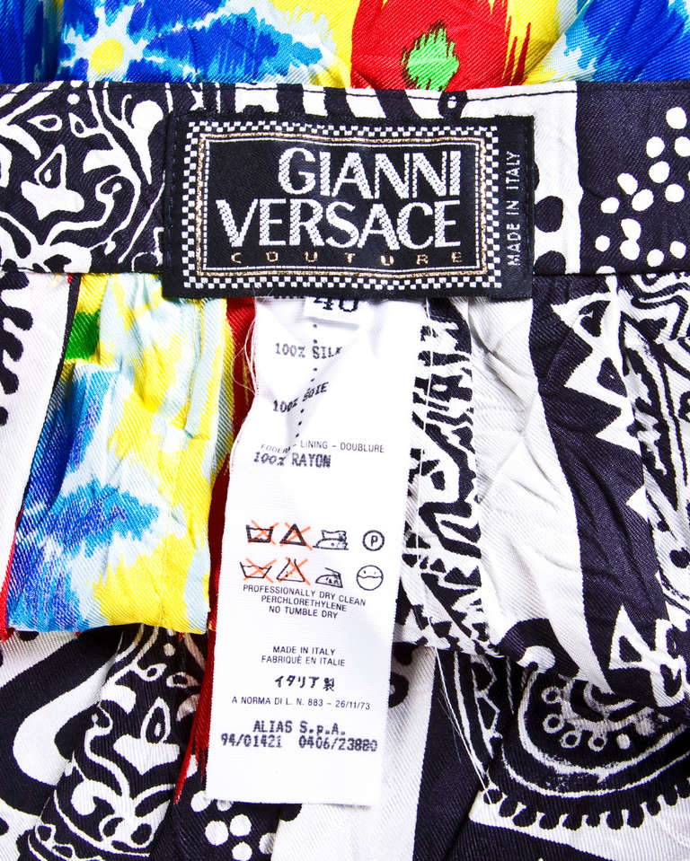 Colorful 1990s printed silk skirt with a Gianni Versace Couture label. Vibrant scarf print with a floral and paisley design.

Details:

Unlined
Side zip and hook closure
Circa: 90s
Label: Gianni Versace Couture
Labeled size: 40
Estimated