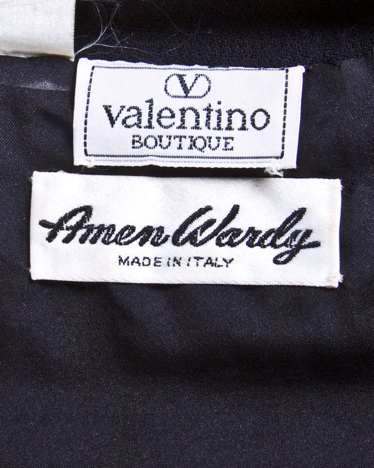 Black and white military-inspired houndstooth jacket and skirt suit by Valentino for Amen Wardy. Versatile lapels can be worn partially unbuttoned or buttoned or asymmetrically in addition to shown as pictured. Front zip and button closure on the