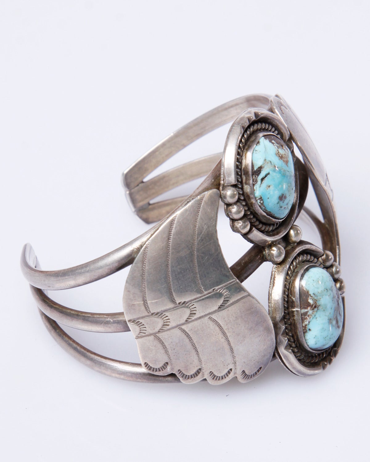 Gorgeous sterling silver Navajo cuff with two chunky turquoise stones. Cuff is adjustable and can be bent to the wearer's wrist size. An absolutely beautiful hand made piece!

Details:

No Closure/ Slip On
Estimated Size: Adjustable
Material: