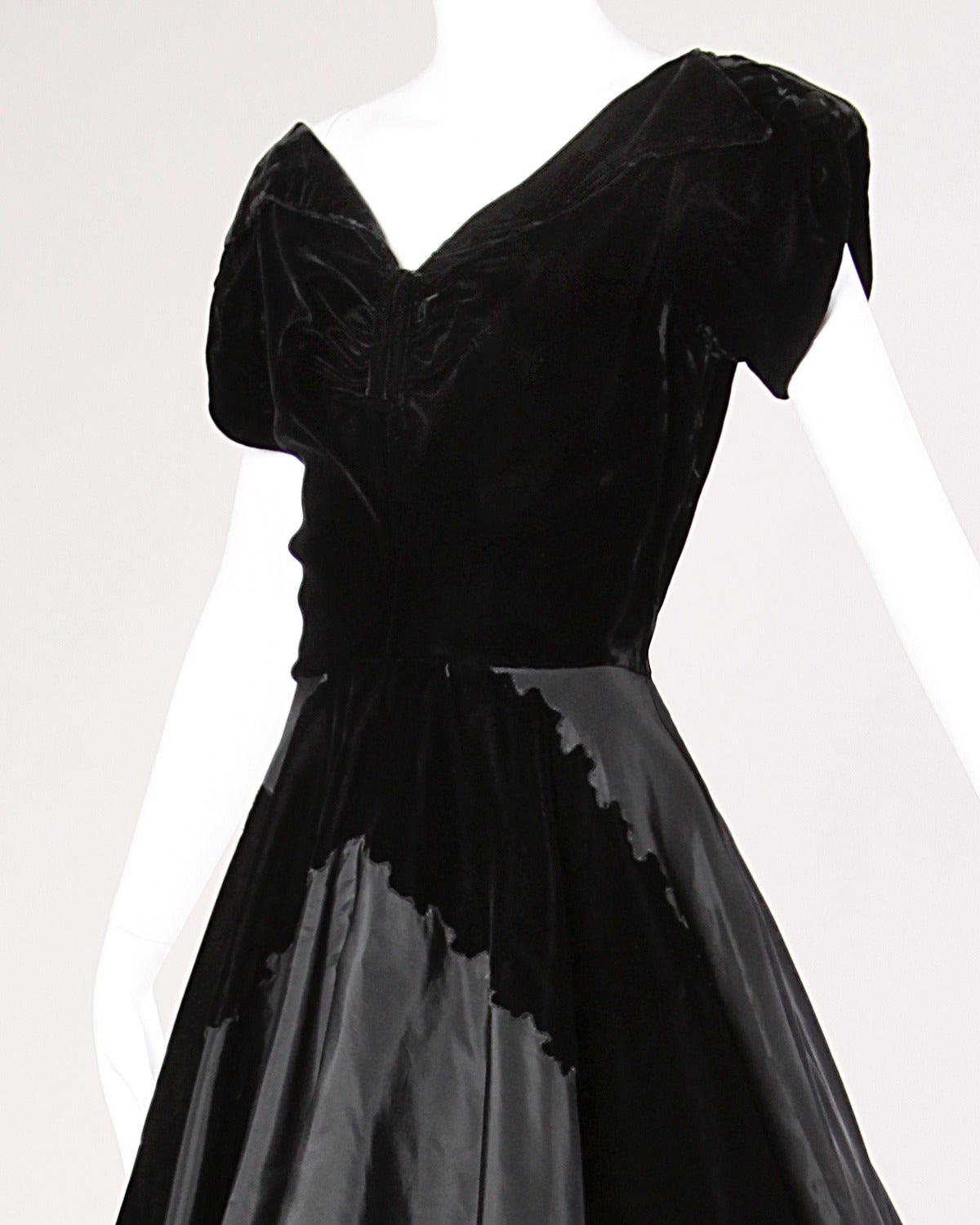 Gorgeous vintage 1950s party dress in black taffeta and velvet. Full sweep and flared skirt.

Details:

Partially Lined
Side Metal Zip Closure
Marked Size: Not Marked
Estimated Size: Medium
Color: Black
Fabric: Taffeta/ Velvet
Label: