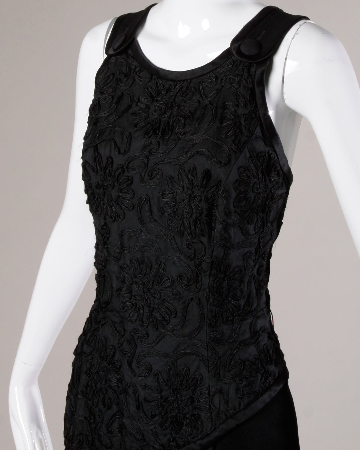 Bill Blass black evening dress with a soutache bodice and asymmetric front slit. 

Details:

Fully Lined
Side Zip Hook Closure/ Front Button Closure
Marked Size: 6
Estimated Size: Small
Color: Black
Fabric: Acetate/ Rayon/ Silk Trim
Label: