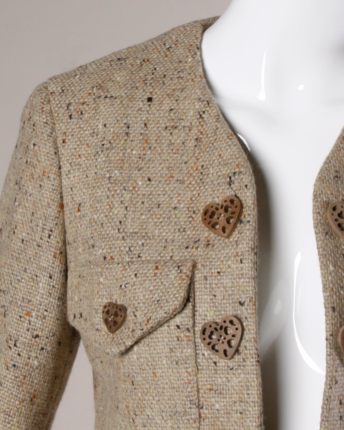 Vintage Moschino skirt suit with adorable carved wooden heart buttons. Envelope front pockets and brown wool tweed.

Details:

Fully Lined
Front Pockets
Shoulder Pads Are Sewn Into Lining
Front Button Closure On Skirt/ No Closure On