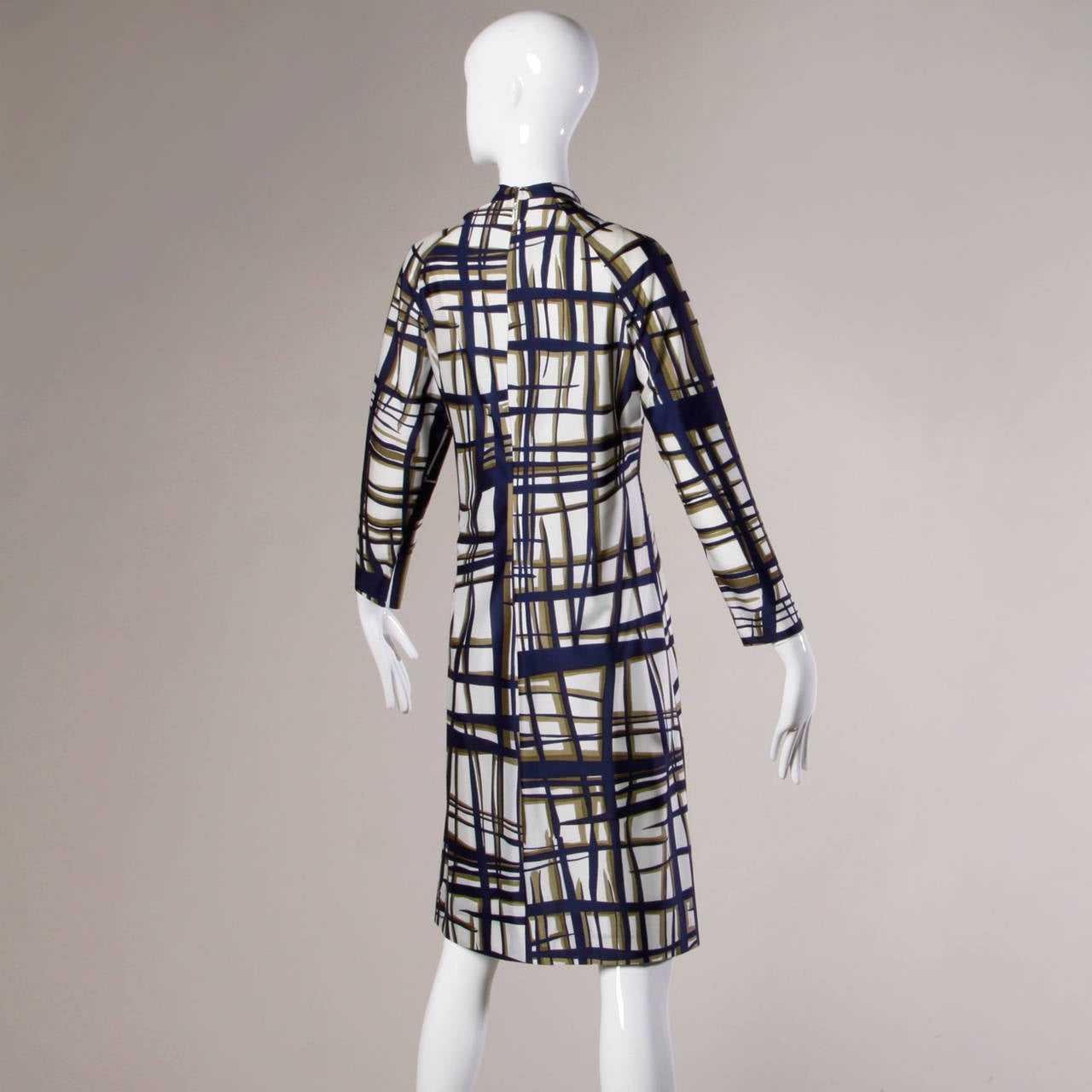 Modernist print shift dress by Adele Simpson with long sleeves.

Details:

Fully Lined
Back Zip and Hook Closure
Marked Size: Not Marked
Estimated Size: S-M
Color: Navy/ Sage Green/ Dark Moss Green
Fabric: Jersey Knit
Label: Adele